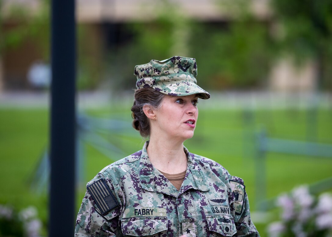 Woman in US Navy utility uniform.