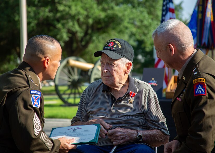 U.S. Army World War II Veteran, Pfc. Reid F. Clanton, is celebrated at the historic Quadrangle of Joint Base San Antonio- Fort Sam Houston, Texas, May 16, 2022, for his contributions while serving in the military during WWII. U.S. Army North leaders paid special tribute to the service of Clanton during a ceremony awarding him long-overdue medals, which included the Bronze Star Medal at the U.S. Army North headquarters. (U.S. Army photo by Pfc. Gianna Elle Sulger)