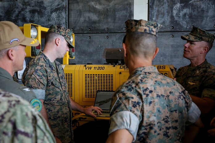 U.S. Marine Corps Gunnery Sgt. Chad J. Pulliammontague, a communications strategy and operations chief, with 13th Marine Expeditionary Unit, presents a three-dimensional model of USS Portland (LPD-27) to Marines and sailors during 13th MEU Loading Exercise visit on May 12, 2022. The purpose of this exercise is to provide information of the supportability of ACVs aboard a LPD-Class ship throughout a six-month deployment.
