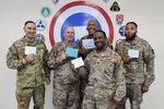 Five of the 135 Soldiers of the 135th Expeditionary Sustainment Command, Alabama National Guard, hold their birthday cards for the last known surviving Tuskegee Airman, Sgt. Victor Butler, who turns 100 May 21, 2022. Left to right, Sgt. 1st Class Brian Lynd, Lt. Col. Joel Traweek, Sgt. 1st Class Willie Vandiver, Capt. Jeremy Barrett, and Sgt. 1st Class Carnard McCalpine.
