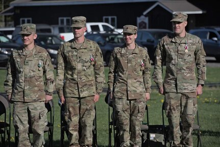 Four U.S. Army Soldiers serving in the Vermont Army National Guard Biathlon Program received medals and recognition on May 14 at Camp Ethan Allen Training Site, Jericho, Vt., for their participation in the 2022 U.S. Biathlon Olympic Team.  Pictured from left to right,  Spc. Vasek Cervenka, Spc. Sean Doherty,  Sgt. Deedra Irwin and Warrant Officer Candidate Leif Nordgren. (U.S. Army National Guard photo by Marcus Tracy)