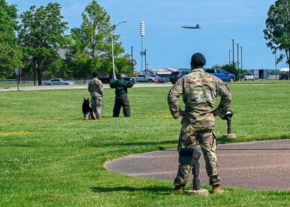 U.S. Air Force Tech. Sgt. Noah Medor, 633d Security Forces Squadron military working dog kennel master, oversees a joint MWD demonstration executed by Senior Airman Tevin Elam, 633d SFS MWD handler, MWD Jony, and the Portsmouth Police Department during the opening ceremony of National Police Week at Joint Base Langley-Eustis, Virginia, May 16, 2022.