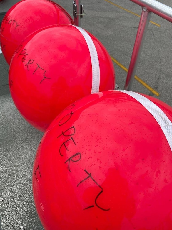 Red buoys with white reflective tape.