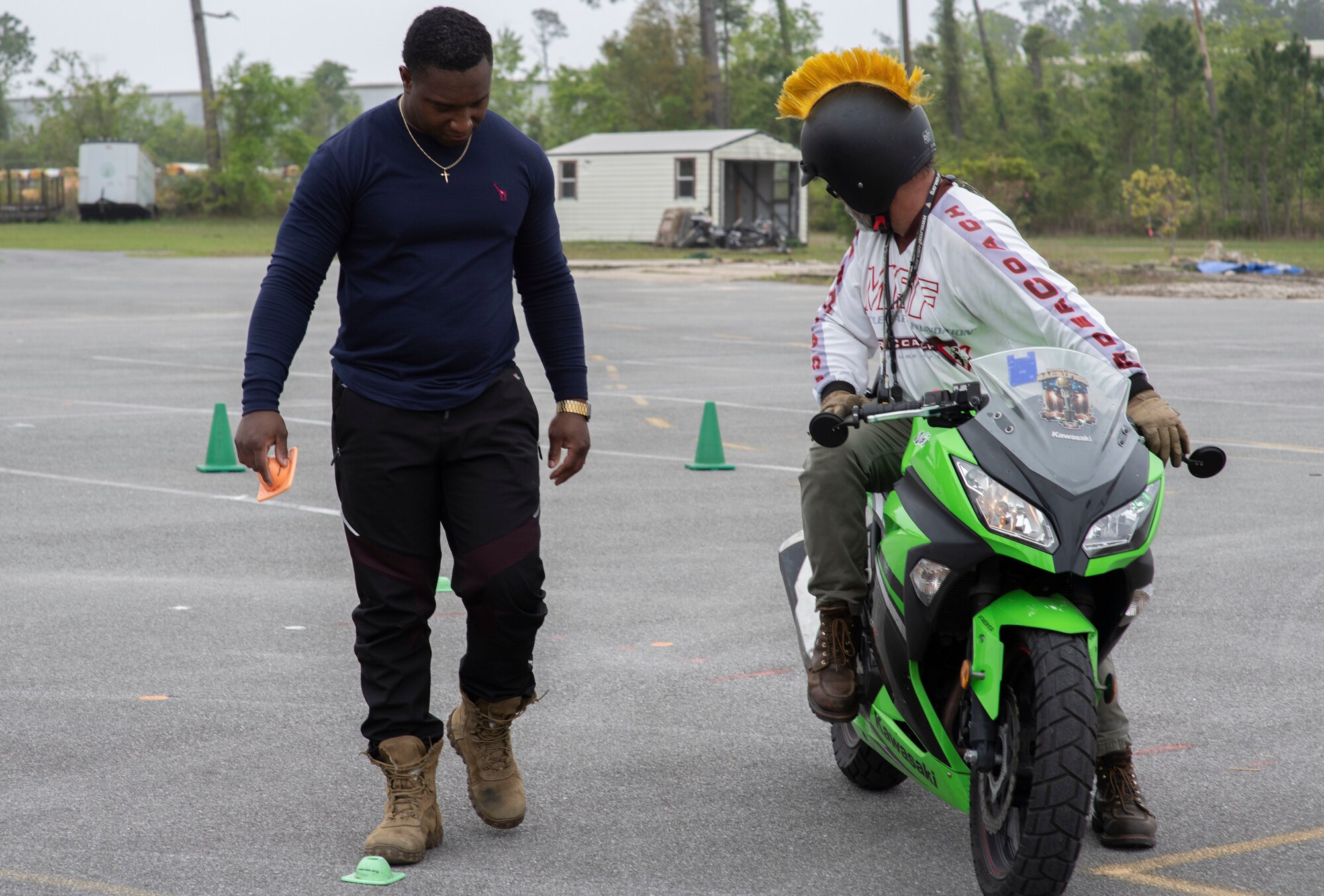 From left, U.S. Air Force Senior Airman Ordavion McChristian, 325th Security Forces Squadron alarm monitor, marks the ground where Shannon Daub, Panama City Motorcycle Training coach, came to a complete stop in Panama City, Florida, April 6, 2022.