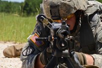Louisiana National Guard's Sgt. William Avery, of Farmerville, Louisiana, with B Company, 3rd Battalion, 156th Infantry Regiment demonstrates different fighting positions that can be used when firing a M249 Light Machine Gun while attending annual training at Fort Polk in Leesville, Louisiana, June 7, 2016. The two-week training allows units to train to increase the overall skill and readiness of the units in the brigade.