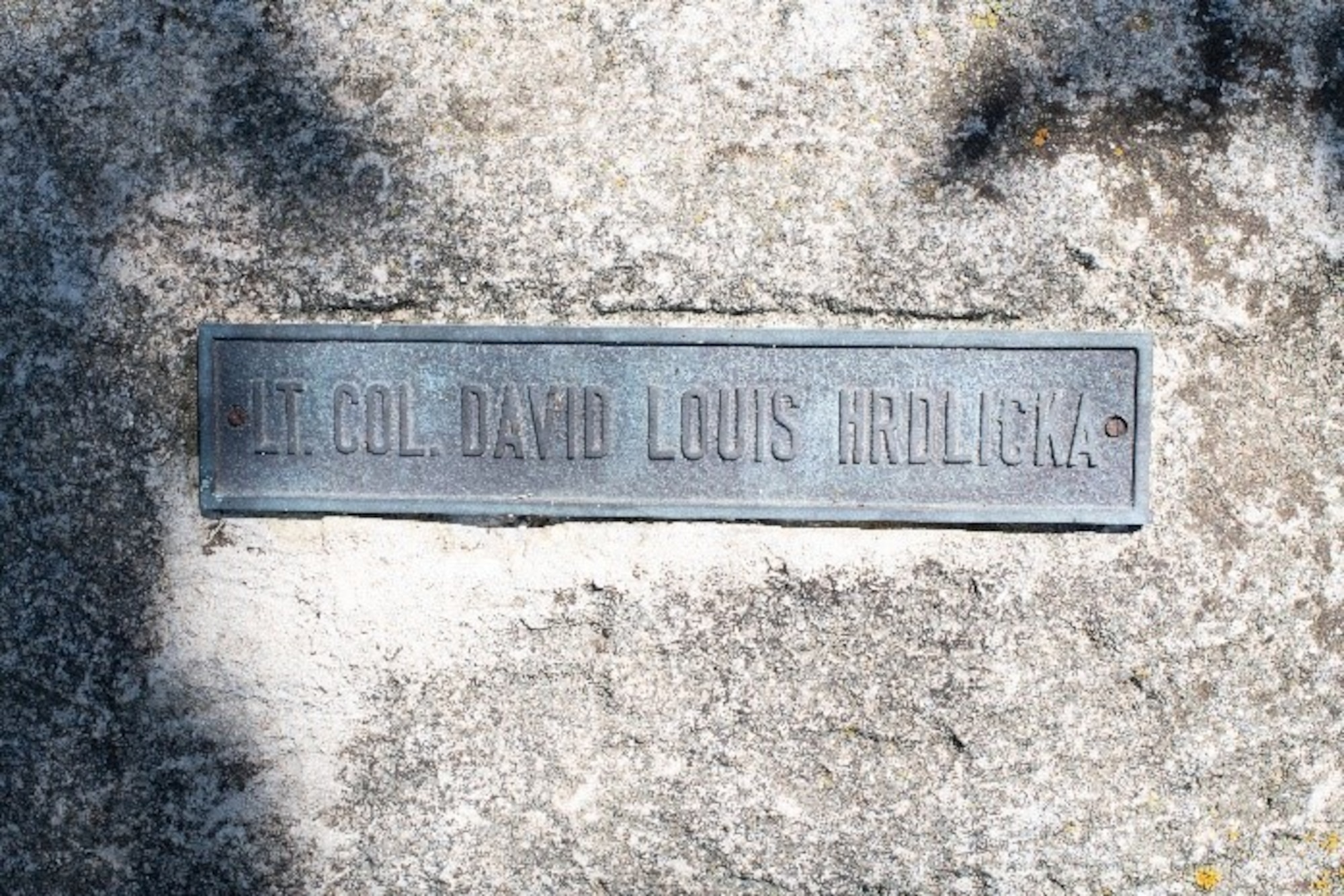 A memorial stone for fighter pilot Lt. Col. David Louis Hrdlicka sits on a memorial walk to honor and remember his life and service at McConnell Air Force Base, Kansas.