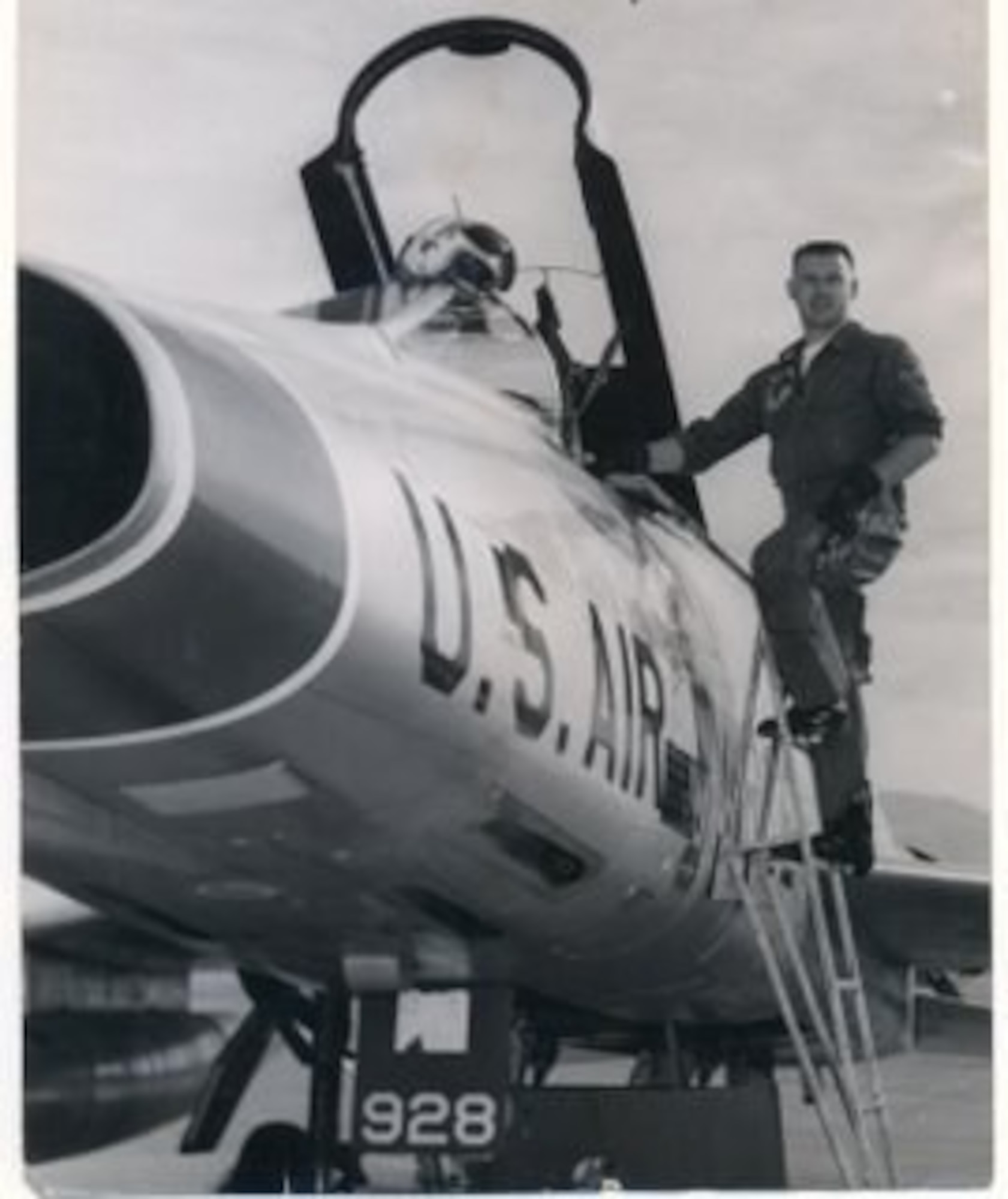 Captain David Hrdlicka poses for a photo alongside an F-100 Super Sabre after a flight in October 1963 at McConnell Air Force Base, Kansas