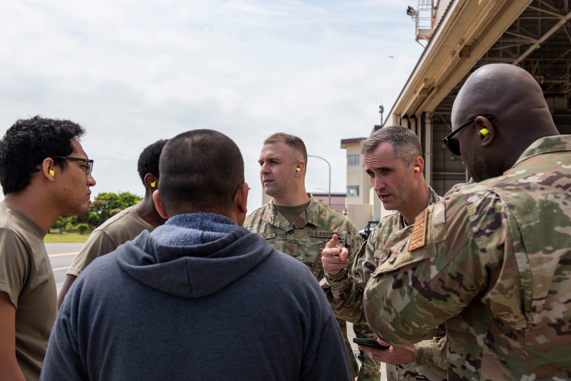 An officer briefs volunteers on the medical training operation about to begin