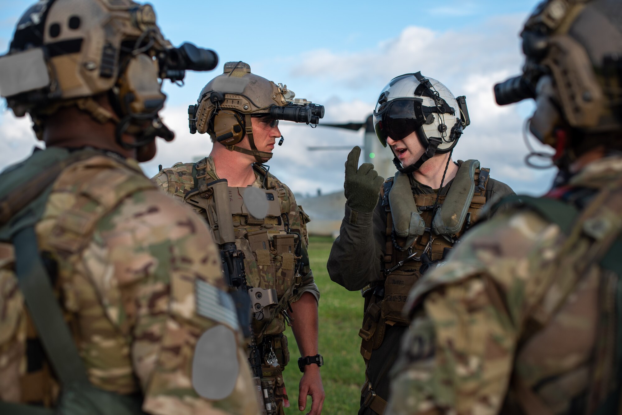 Soldier and Marine prepare to board a helicopter.