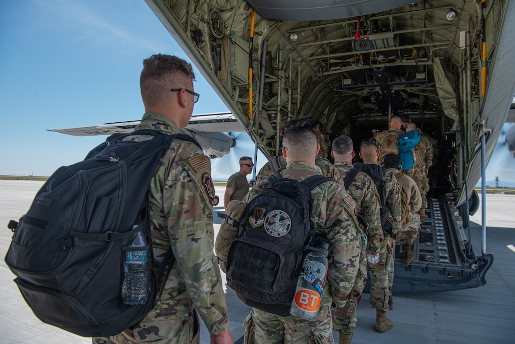 U.S. Air Force Airmen assigned to the 366th Fighter Wing board a C-130J Hercules, assigned to the 317th Airlift Wing, Dyess Air Force Base, Texas, as part of Exercise Raging Gunfighter at Mountain Home Air Force Base, Idaho, May 17, 2022. Raging Gunfighter is an Air Combat Command (ACC) exercise to prepare the 366th Fighter Wing to operate as a lead wing in a remote environment for future Agile Combat Employment (ACE) operations around the world. (U.S. Air Force Photo by Airman 1st Class Alexandria Byrd)