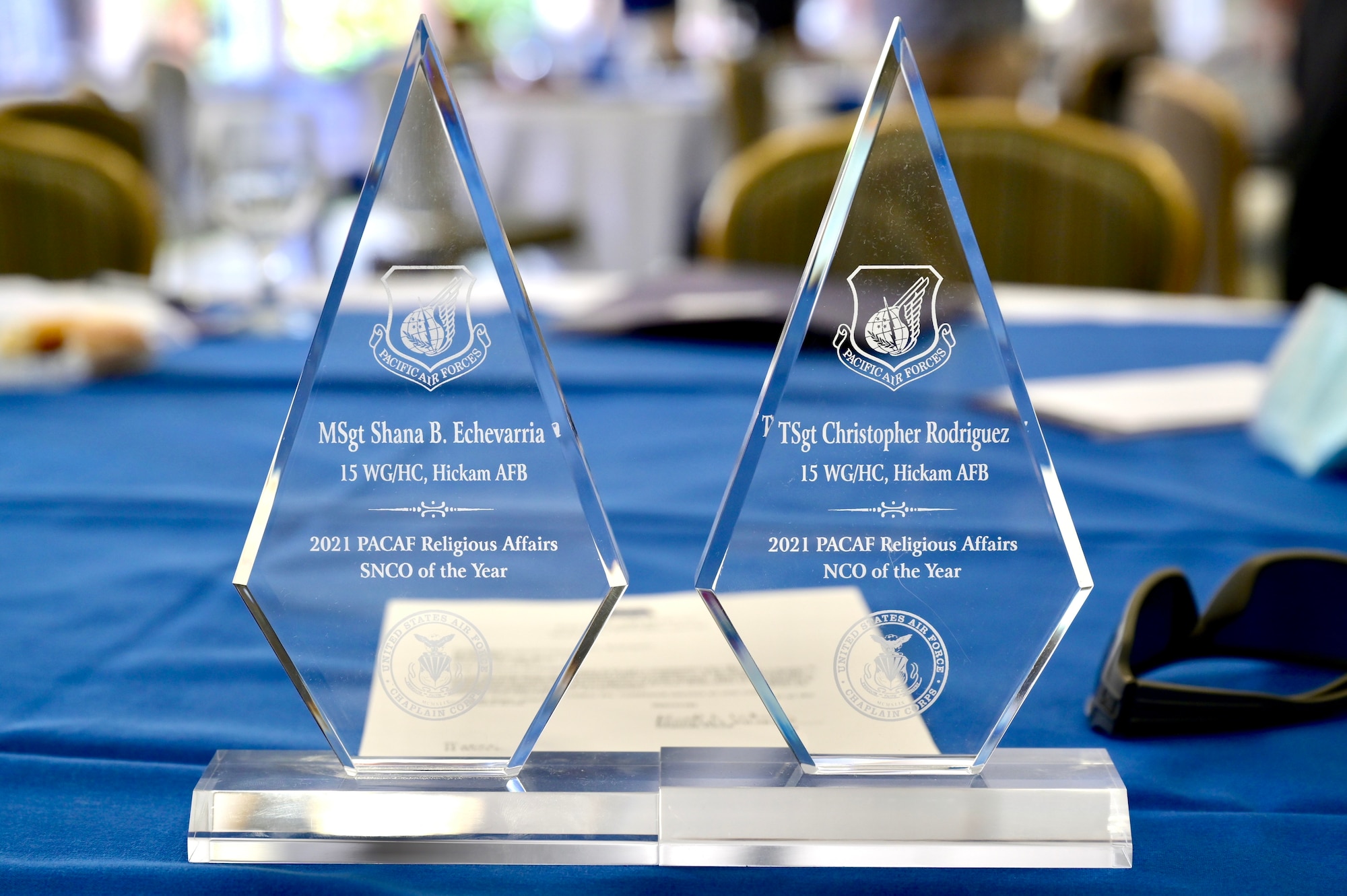 Awards for the 2021 Pacific Air Force Religious Affairs Senior Non-Commissioned Officer and Non-Commissioned Officer sit on a table after being accepted by the recipients during a Cultural Religious Leader Engagement event at Joint Base Pearl Harbor-Hickam, Hawaii, May 12, 2022. Col. Christopher LaPack, Pacific Air Forces command chaplain, presented the awards to members of the 647th Air Base Group chaplain corps. (U.S. Air Force photo by 1st Lt. Benjamin Aronson)