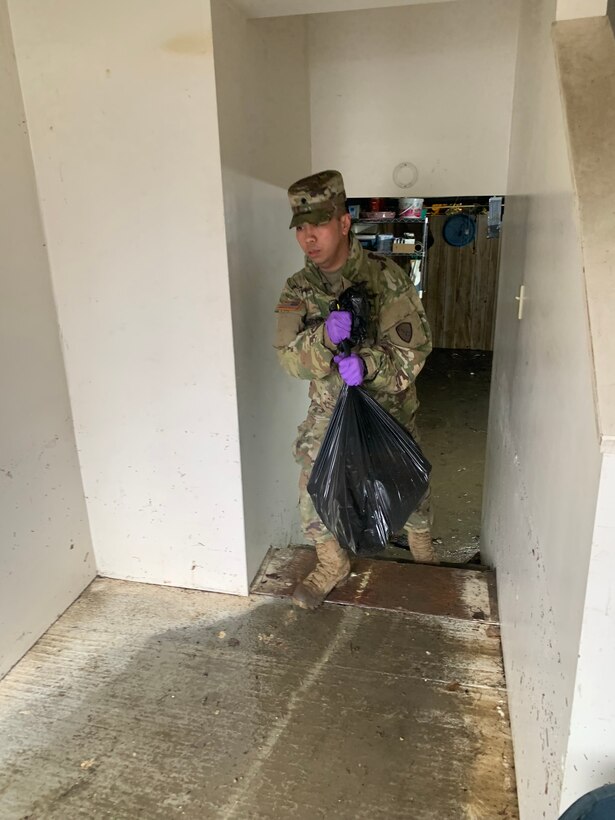 Alaska Army Guard Spc. Steven Romero, with the 297th Military Police Company, assists with cleanup and flood recovery efforts in Manley Hot Springs May 12, 2022.