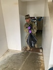 Alaska Army Guard Spc. Steven Romero, with the 297th Military Police Company, assists with cleanup and flood recovery efforts in Manley Hot Springs May 12, 2022.