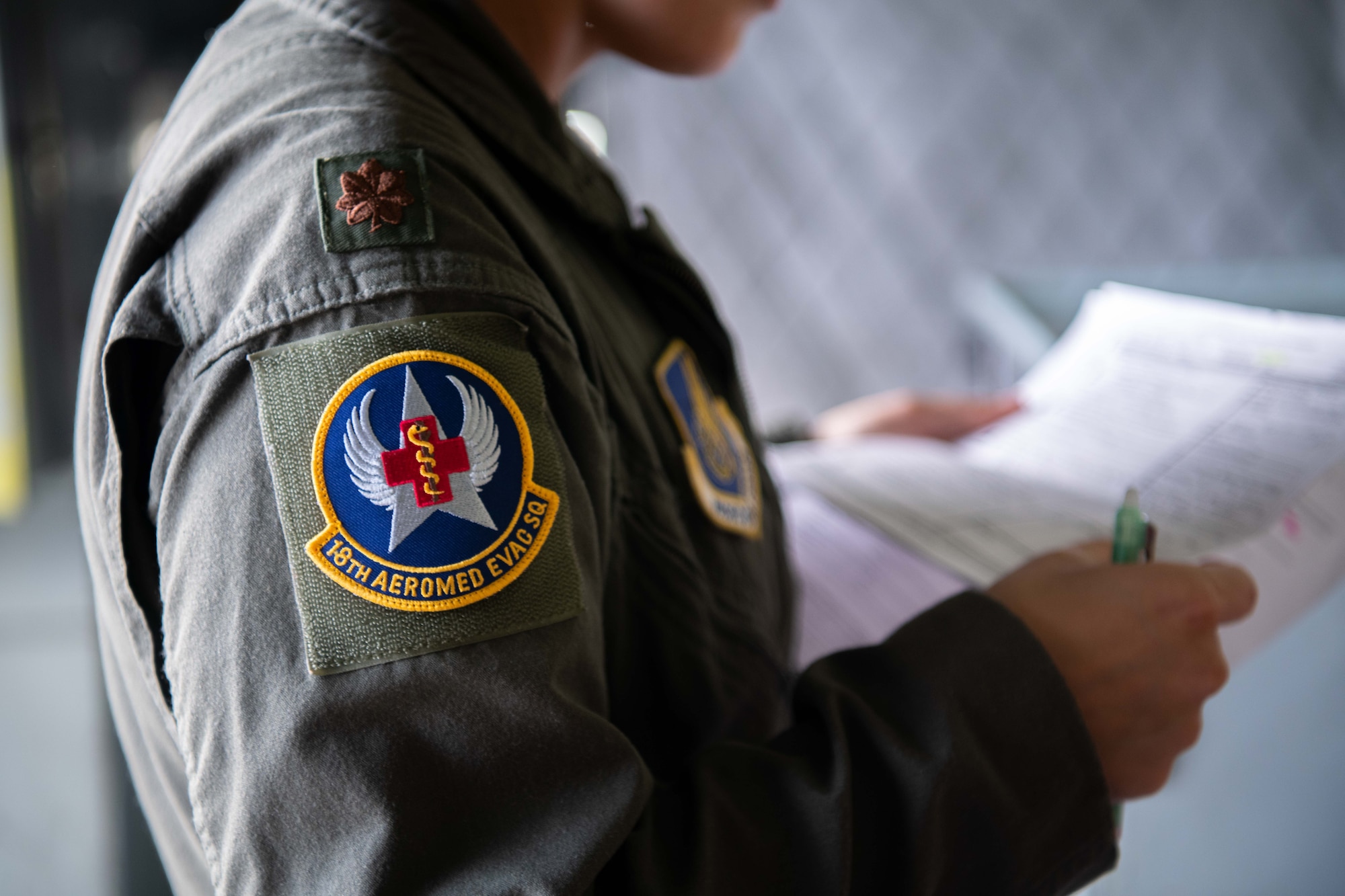An 18th Aeromedical Evacuation Squadron patch is displayed on the uniform of a flight nurse.