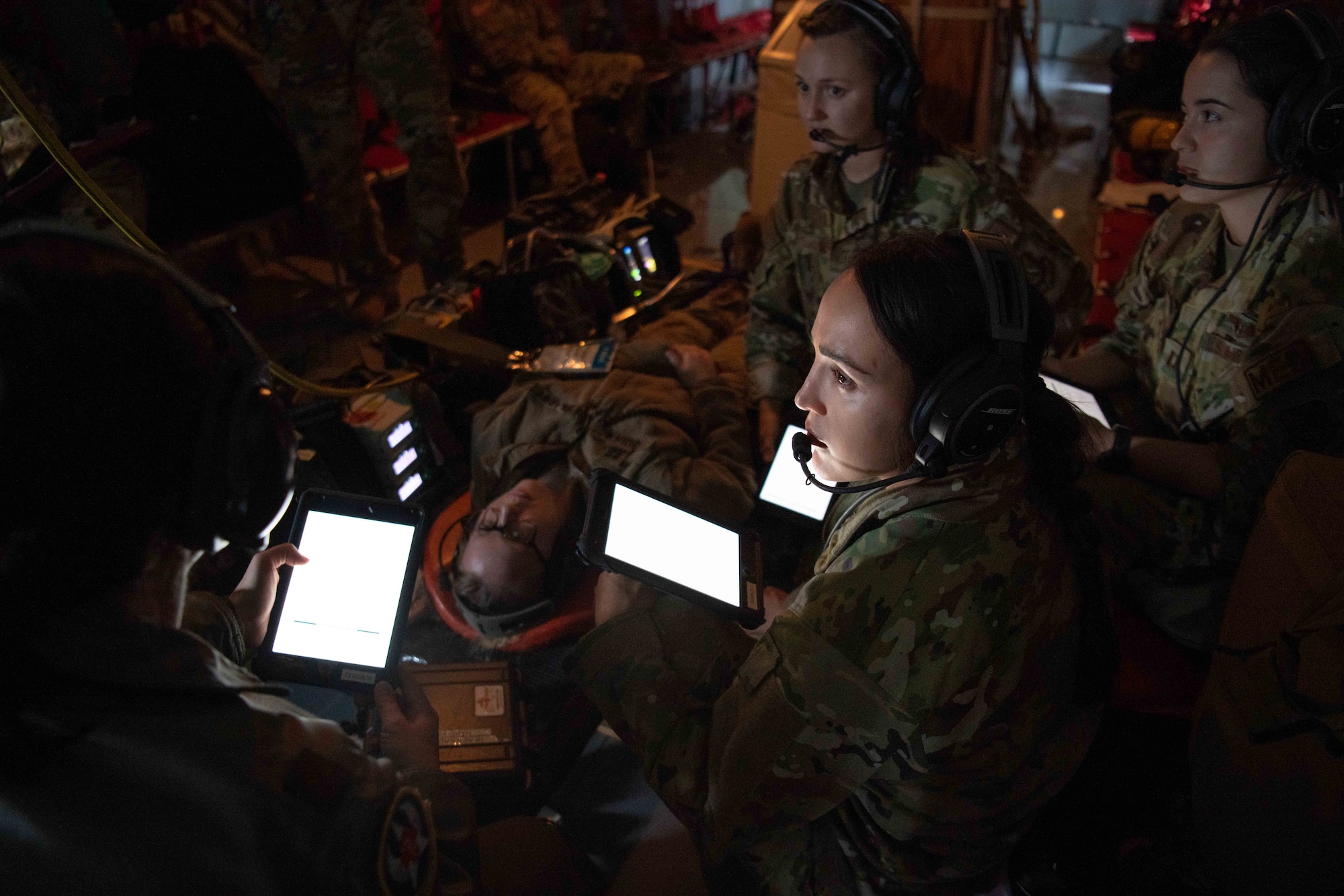 A group of Airmen conduct a scenario for treating a seizure patient.