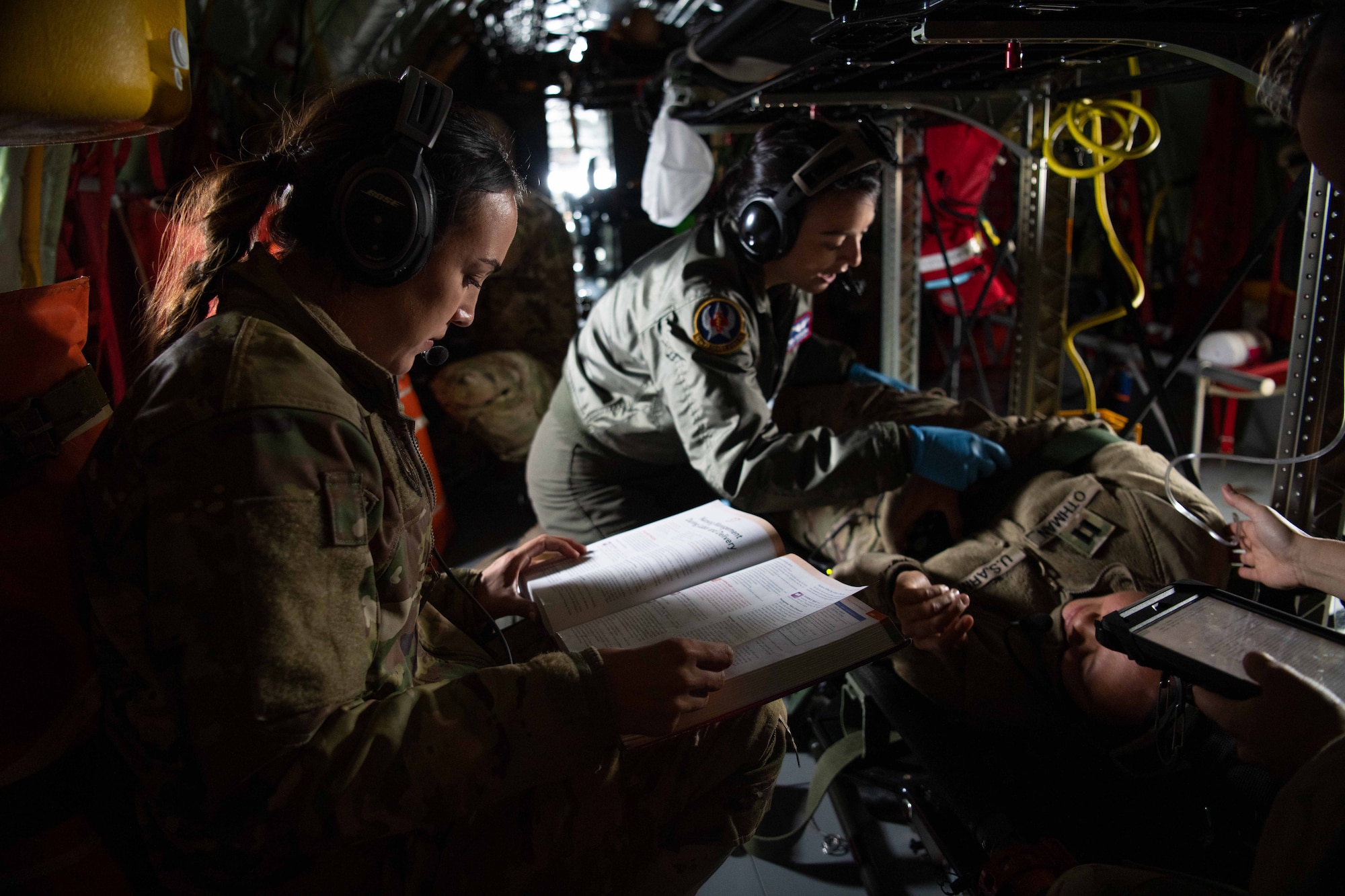 An Airman reads a book on delivery procedures.