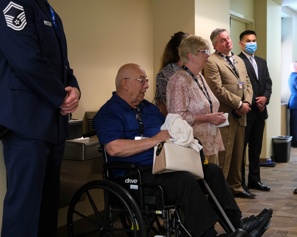 Family members pause during the Celebration of Life event at the Office of Special Investigations headquarters Hall of Heroes, at Quantico, Va., May 17, 2022. The Hall is lined with photos of Fallen OSI Special Agents, a professional staff member and two Security Forces defenders who were killed in the line of duty representing OSI. (U.S. Air Force photo by Staff Sgt. Joshua King)