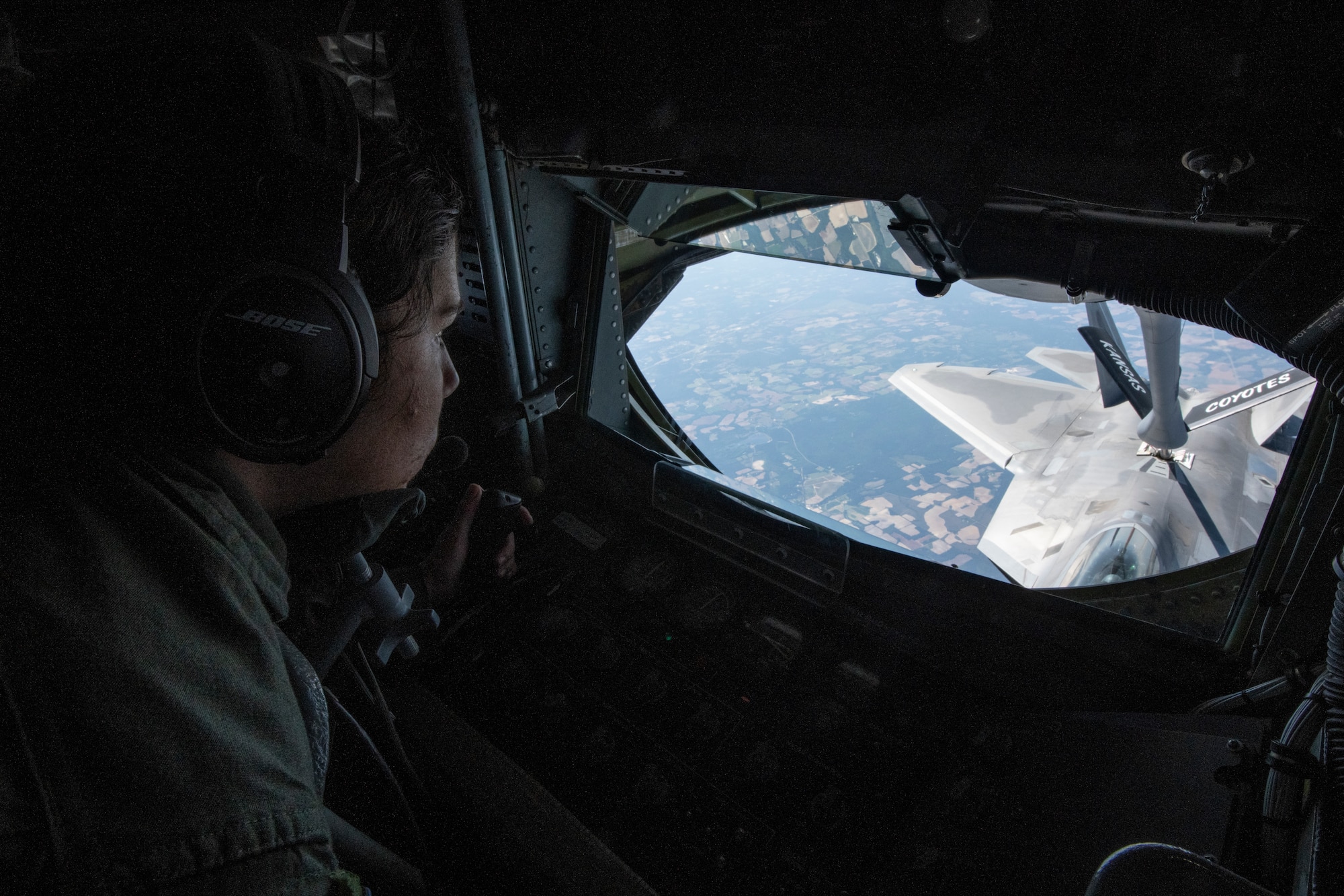 U.S. Air Force Staff Sgt. Kelsey Warren, a KC-135 Stratotanker boom operator with the 190th Air Refueling Wing, Kansas Air National Guard, refuels an F-22 Raptor with the 325th Fighter Wing, during Sentry Savannah May 11, 2022,  in a military operations area over Florida. Three air refueling units from across the Air National Guard provided in-flight refueling in support of Sentry Savannah 2022, the ANG’s premier counter air exercise which encompasses 10 units of fourth and fifth generation fighter aircraft, tests the capabilities of our warfighters in a simulated near-peer environment and trains the next generation of fighter pilots for tomorrow’s fight. (U.S. Air National Guard photo by Staff Sgt. Hanna Smith)
