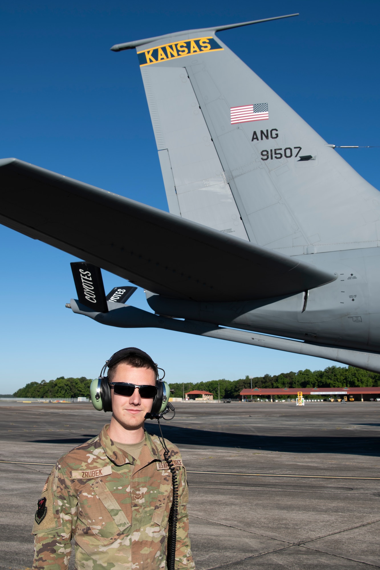A U.S. Air Force KC-135 Stratotanker crew chief with the 190th Air Refueling Wing, Kansas Air National Guard, poses for a photo on the flightline May 11, 2022, at Hunter Army Airfield, Georgia. Exercises like Sentry Savannah held at the Air Dominance Center not only train and test the counter air capabilities of the next generation of fighter pilots, but they also provide critical experience and training to 10 different units of maintenance Airmen in the rapid employment and recovery of aircraft. (U.S. Air National Guard photo by Staff Sgt. Hanna Smith)