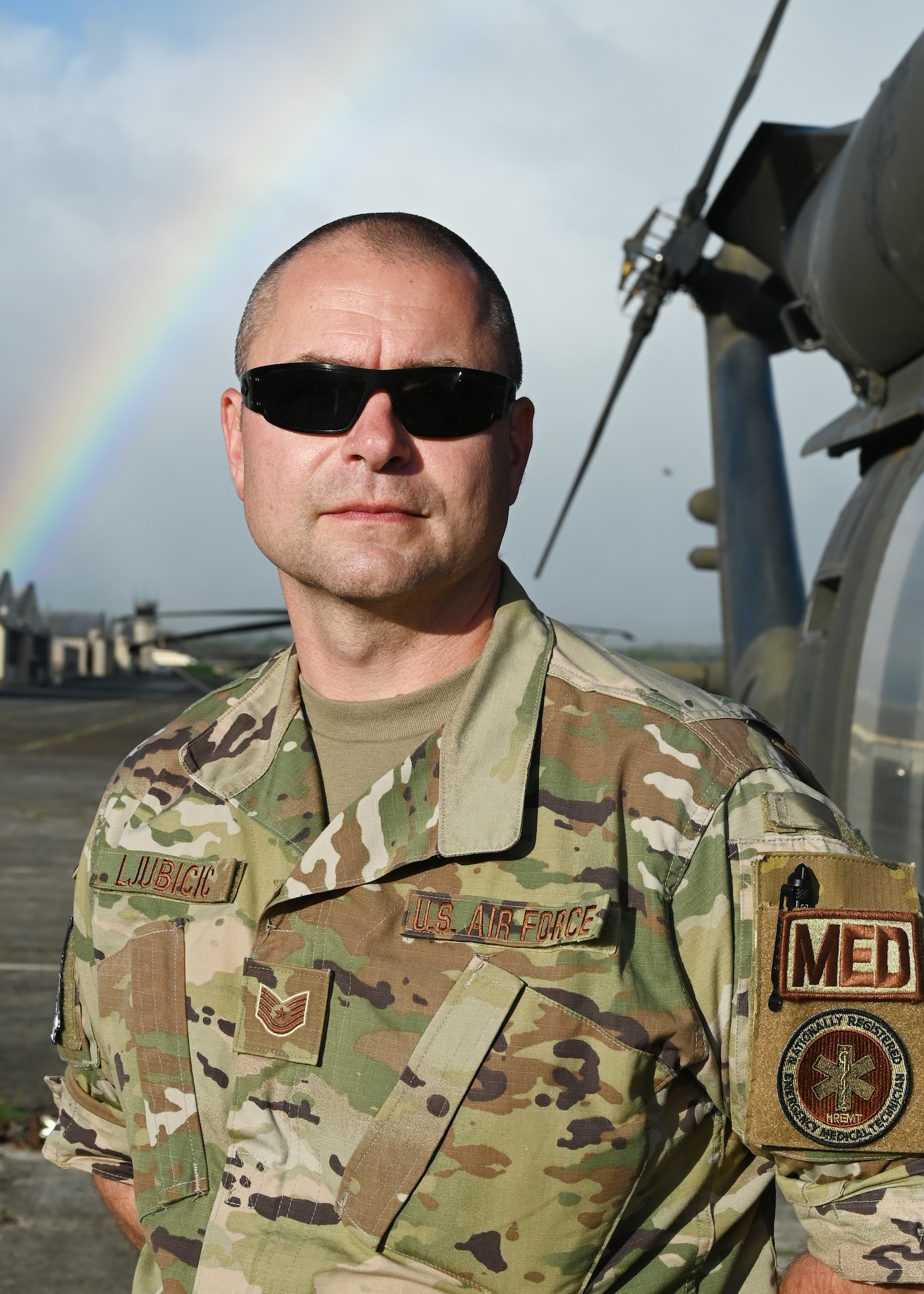 Tech. Sgt. Paul Ljubicic, 104th Medical Group aerospace medical technician, stands in front of an Army UH-60 Black Hawk helicopter after a morale flight at Wheeler Army Airfield, Hawaii, May 3, 2022. Ljubicic planned the morale flight for the Airmen after completing training requirements at Tripler Army Medical Center. (U.S. Air National Guard Photo by Senior Airman Camille Lienau)