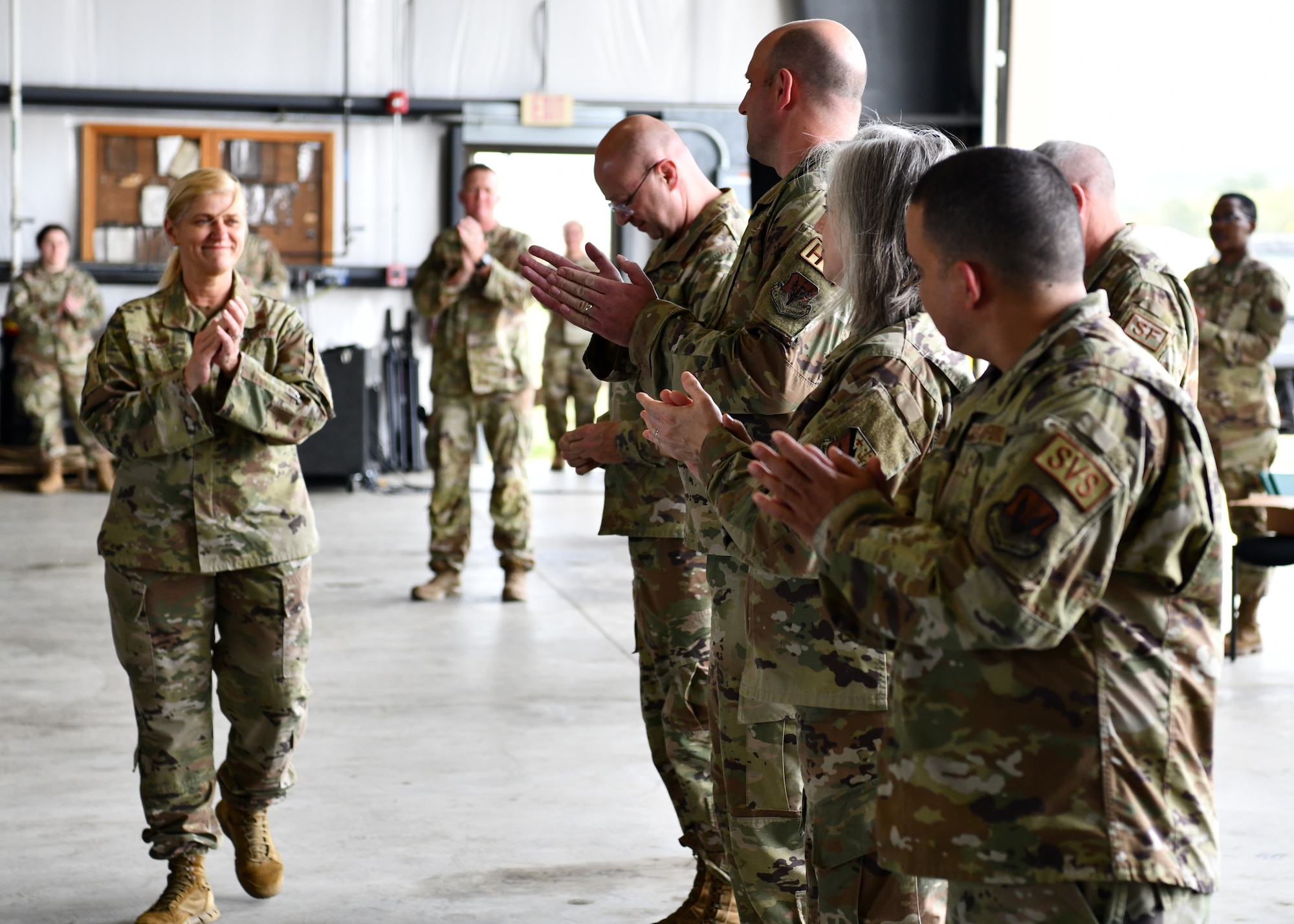 Brig. Gen. Virginia Gaglio, Air Component Commander of the Massachusetts Air National Guard, congratulates Airmen during the TF Powderhorn awards ceremony at Barnes Air National Guard Base, Massachusetts, May 14, 2022. Fifty four Barnestormers were awarded Army Achievement Medals for their outstanding performance during TF Powderhorn, an activation where members supported state medical facilities.  (U.S. Air National Guard Photo by Senior Airman Camille Lienau)