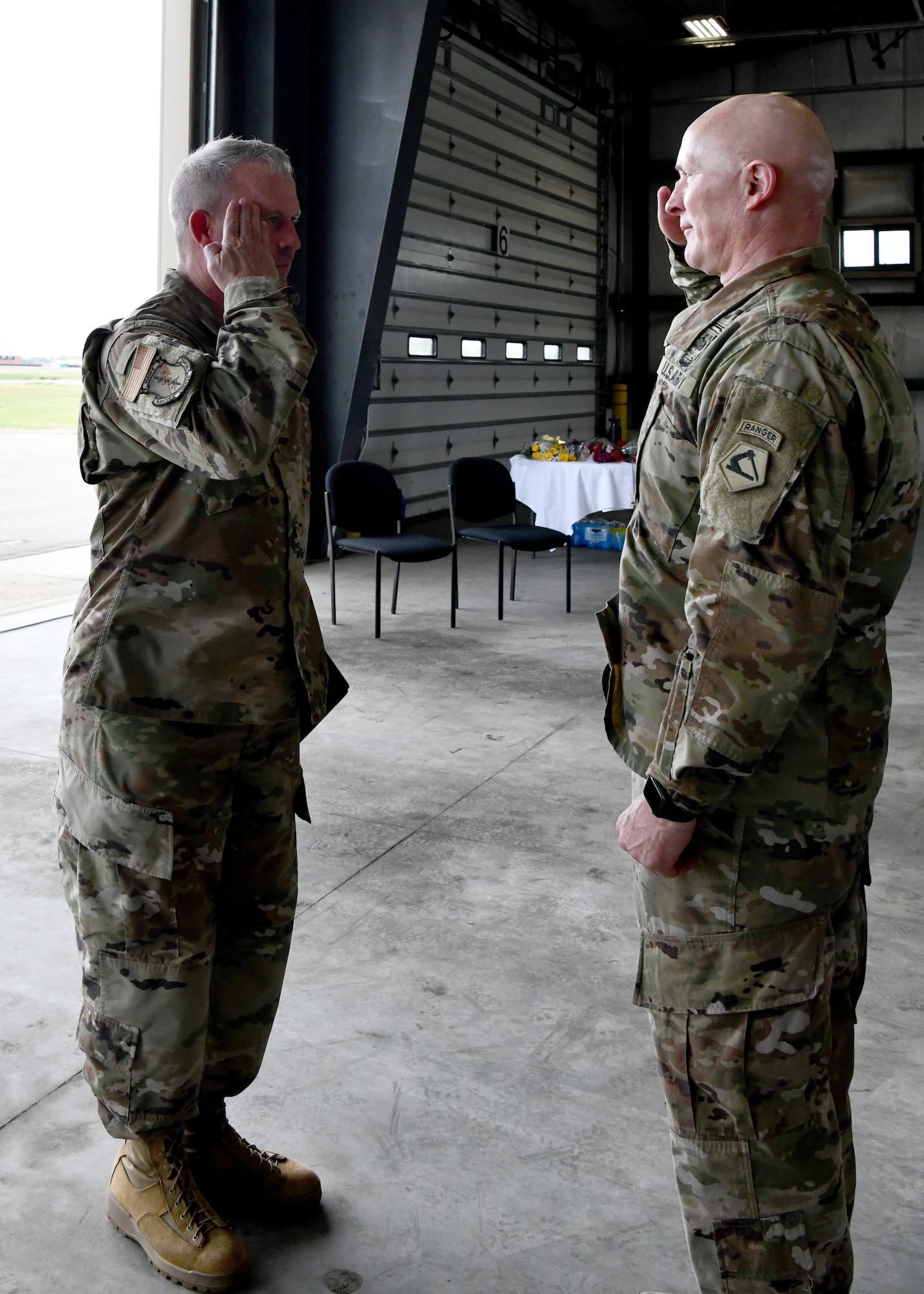 Senior Master Sgt. Thomas Moriarty, 104th Fighter Wing Operations Group first sergeant, salutes U.S. Army Lt. Col. Patrick Donnelly, Task Force Powderhorn senior leader, during the TF Powderhorn awards ceremony at Barnes Air National Guard Base, Massachusetts, May 14, 2022.  Fifty four Barnestormers were awarded Army Achievement Medals for their outstanding performance during TF Powderhorn, an activation where members supported state medical facilities. (U.S. Air National Guard Photo by Senior Airman Camille Lienau)