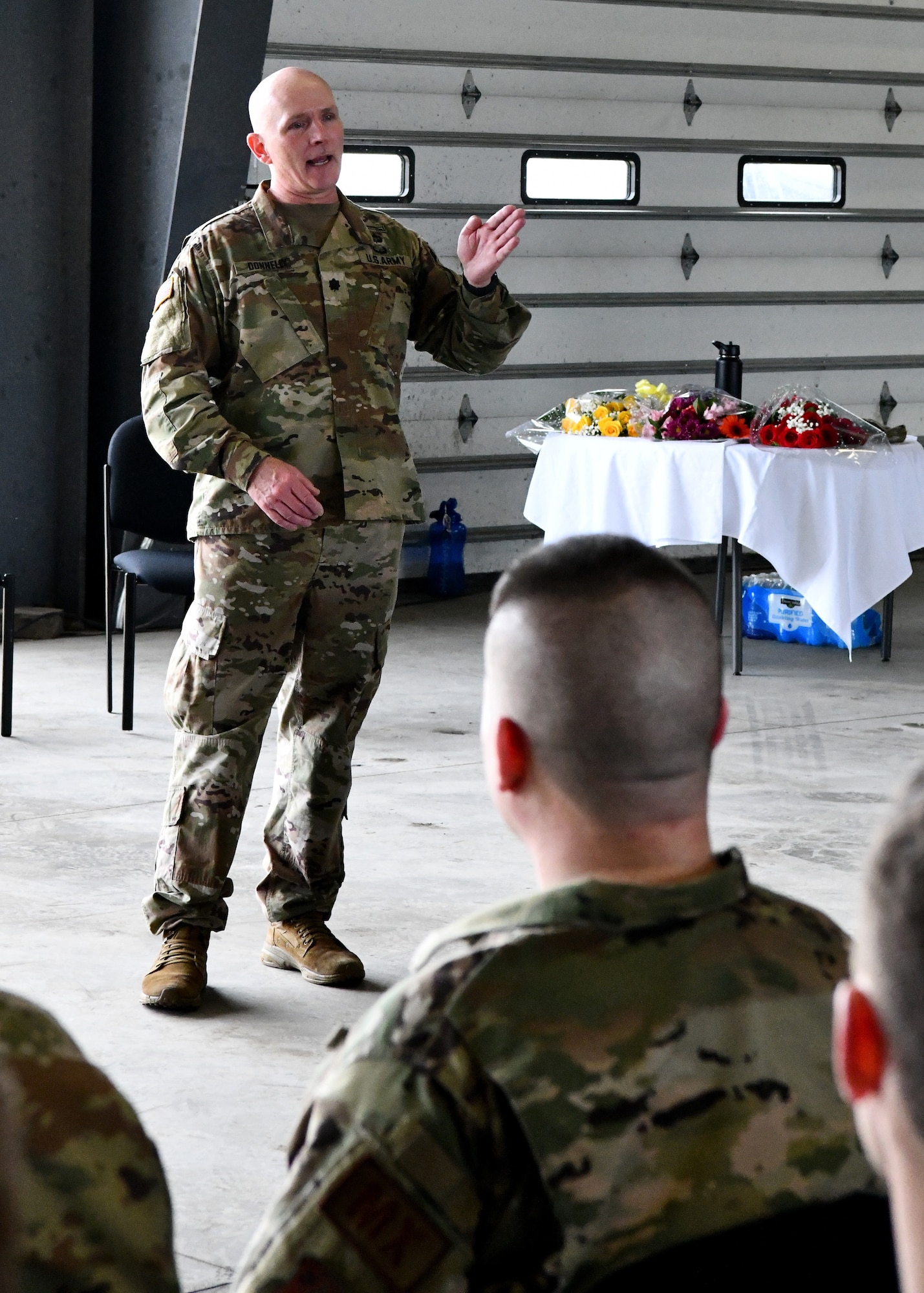 U.S. Army Lt. Col. Patrick Donnelly, Task Force Powderhorn senior leader, addresses Airmen during the TF Powderhorn awards ceremony at Barnes Air National Guard Base, Massachusetts, May 14, 2022. Fifty four Barnestormers were awarded Army Achievement Medals for their outstanding performance during TF Powderhorn, an activation where members supported state medical facilities. (U.S. Air National Guard Photo by Senior Airman Camille Lienau)