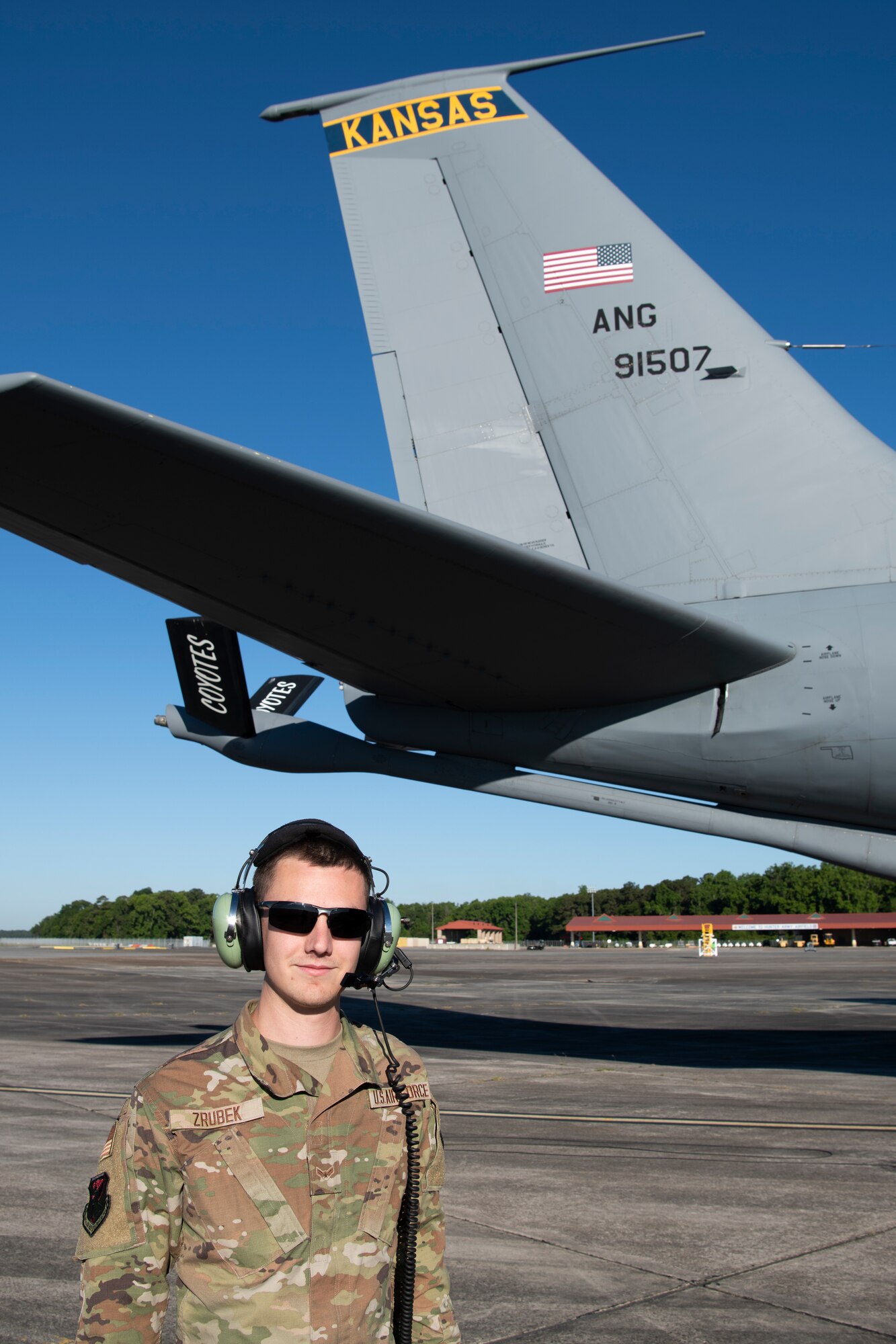 A U.S. Air Force KC-135 Stratotanker crew chief with the 190th Air Refueling Wing, Kansas Air National Guard, poses for a photo on the flightline May 11, 2022, at Hunter Army Airfield, Georgia. Exercises like Sentry Savannah held at the Air Dominance Center not only train and test the counter air capabilities of the next generation of fighter pilots, but they also provide critical experience and training to 10 different units of maintenance Airmen in the rapid employment and recovery of aircraft. (U.S. Air National Guard photo by Staff Sgt. Hanna Smith)