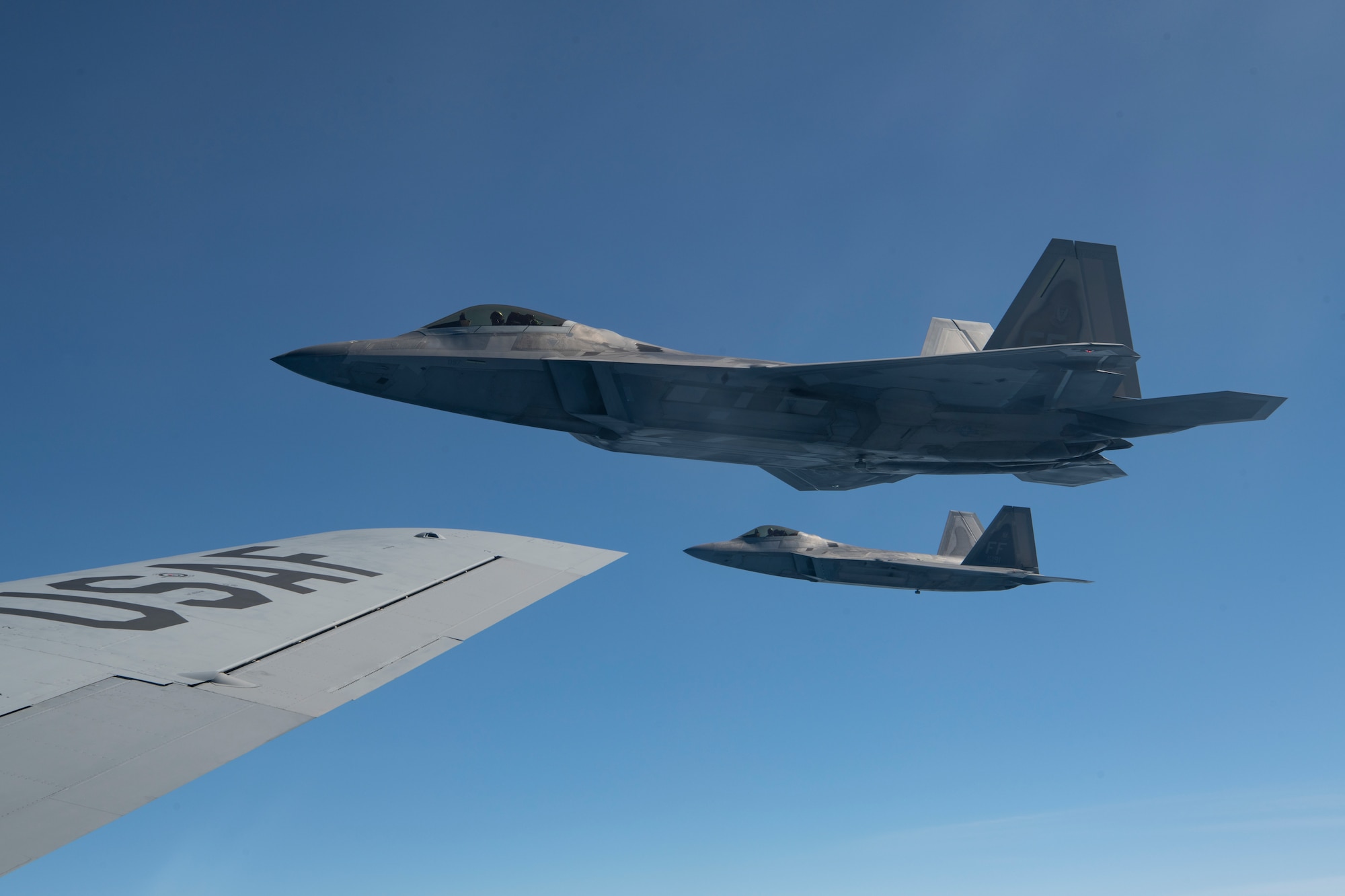 U.S. Air Force F-22 Raptors with the 192nd Fighter Wing, fly alongside a KC-135 Stratotanker with the 117th Air Refueling Wing, after in-flight refueling during exercise Sentry Savannah May, 5, 2022, in a military operations area off the coast of Georgia. Sentry Savannah is a joint total force integrated exercise that showcases the nation's combat aircraft readiness, tests the capabilities of our warfighters in a near-peer environment and trains our next generation of fighter pilots for tomorrow’s fight. (U.S. Air Force photo by Staff Sgt. Hanna Smith)