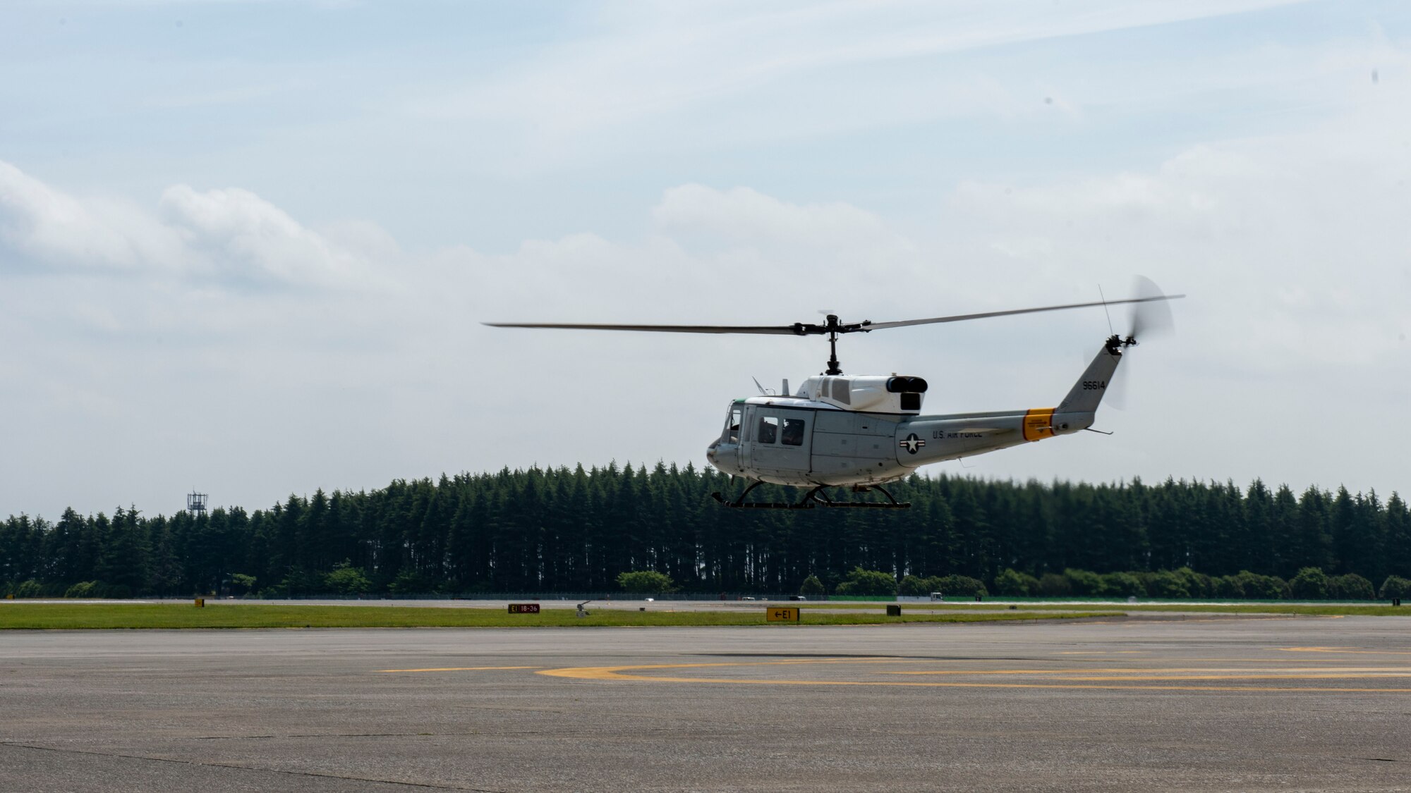 A helicopter takes off from the flightline