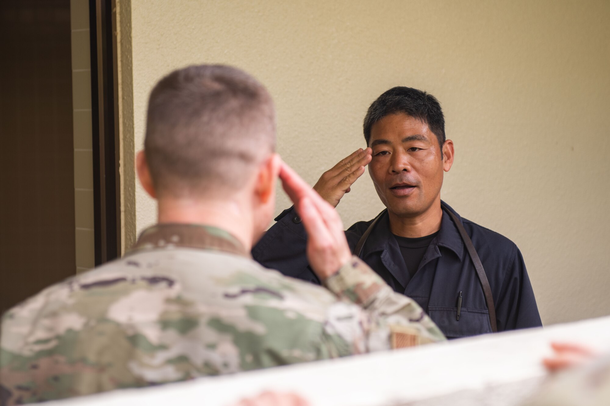 A JASDF civilian guard salutes an Air Force O