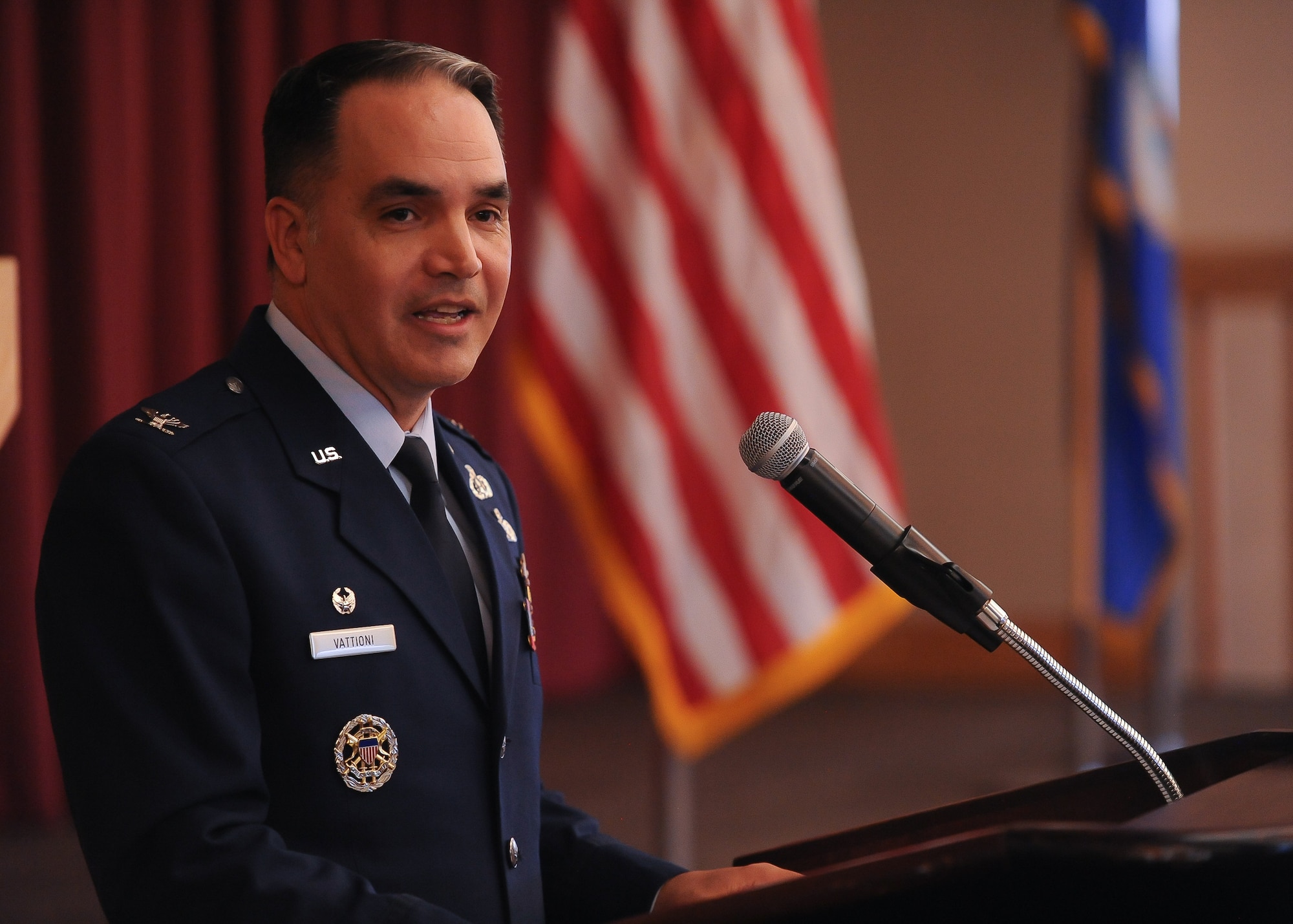 A man speaks at a podium.