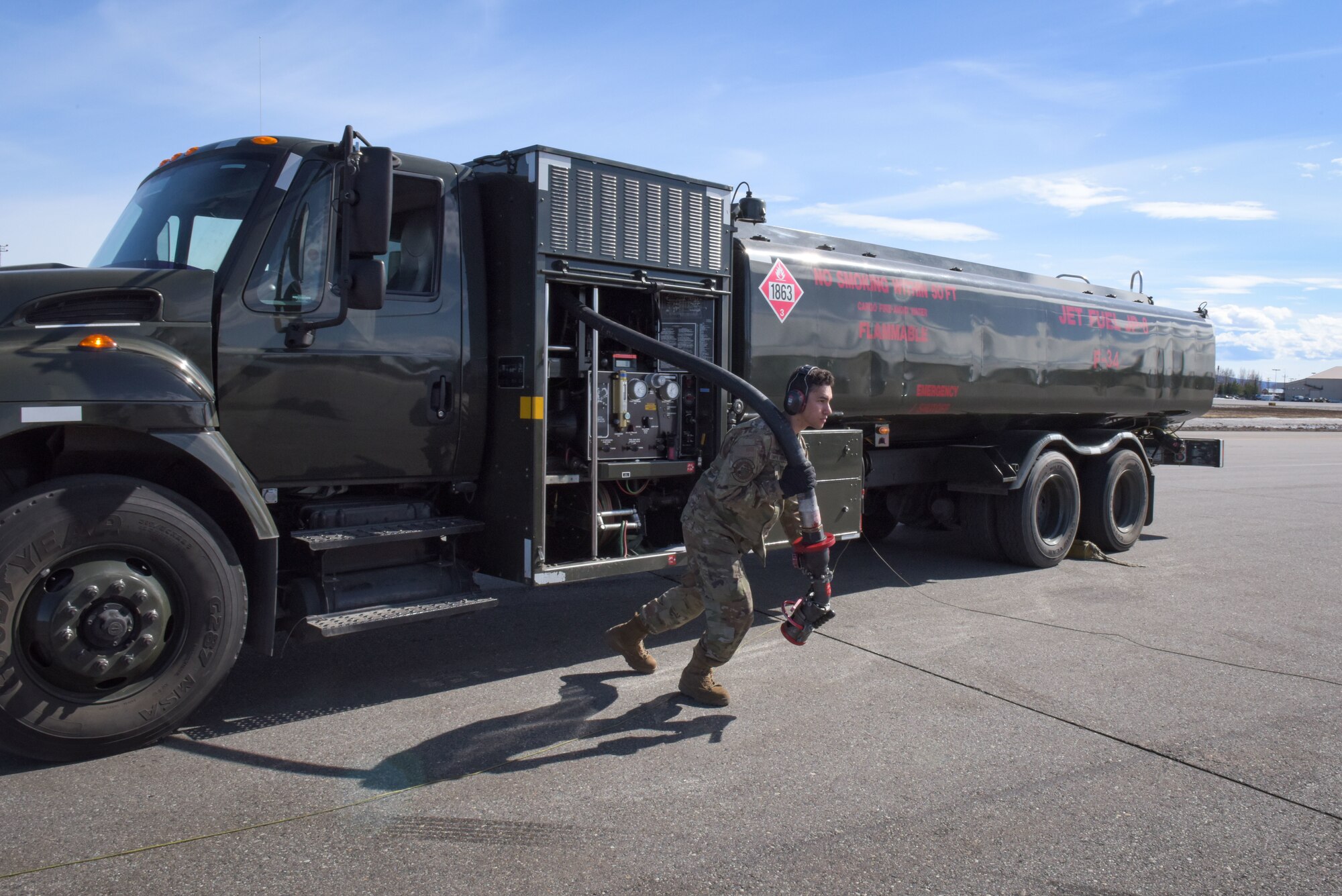 U.S. Air Force Airman Santiago Pompa Rivera, 354th Logistic Readiness Squadron fuels distribution apprentice, pulls a fuel hose to refuel an F-16 Fighting Falcon during RED FLAG-Alaska 22-1 at Eielson Air Force Base, May 4, 2022.