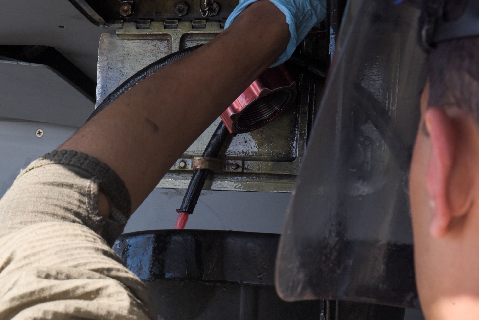 U.S. Air Force Zakeria Qasemi, 36th Aircraft Maintenance Unit crew chief, drains hydraulic fluid from an F-16 Fighting Falcon during RED FLAG-Alaska 22-1 at Eielson Air Force Base, May 4, 2022.