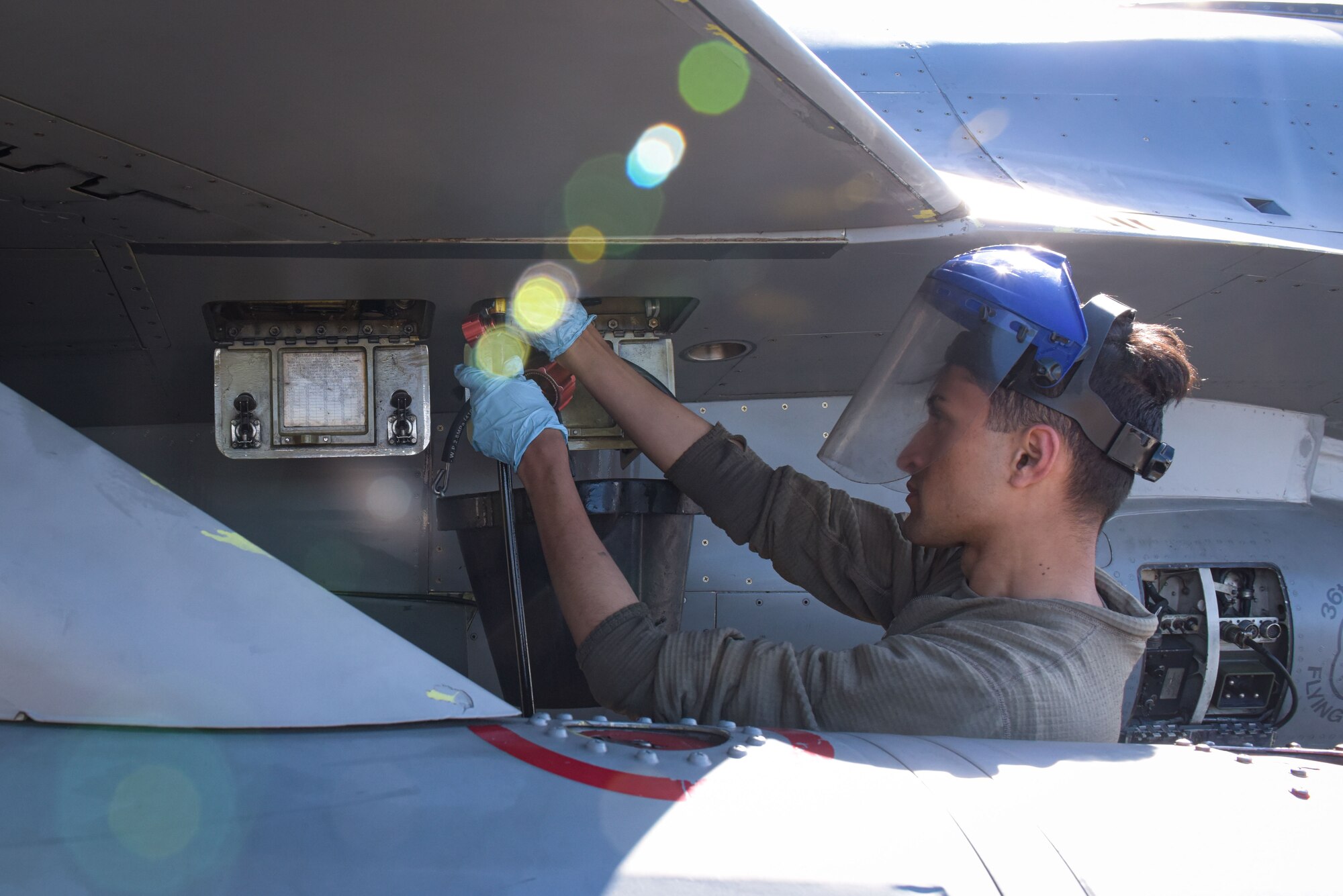 U.S. Air Force Zakeria Qasemi, 36th Aircraft Maintenance Unit crew chief, services an F-16 Fighting Falcon during RED FLAG-Alaska 22-1 at Eielson Air Force Base, May 4, 2022.