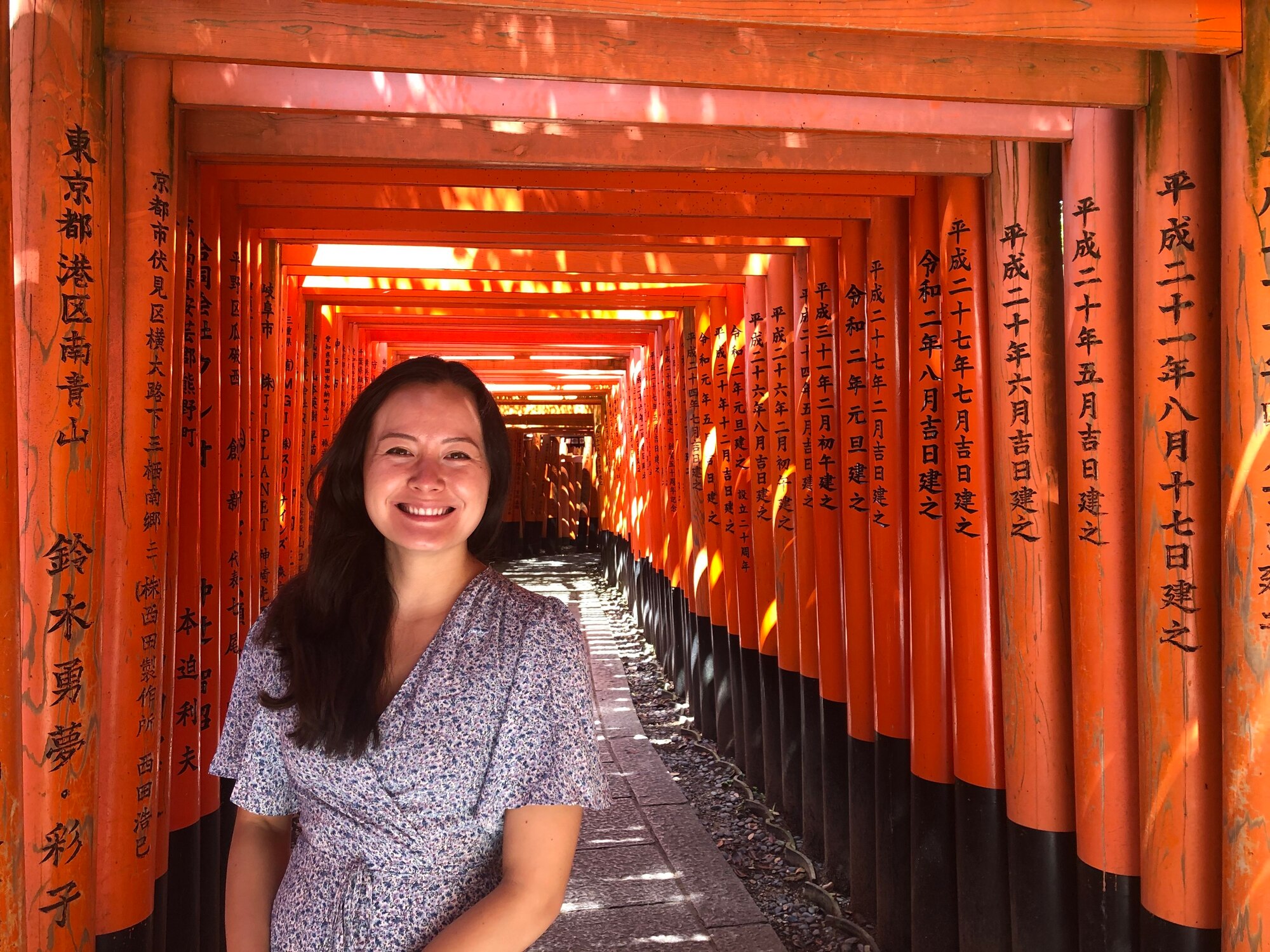 Abyy Fenn stands inside the Fushimi Inari Shrine.