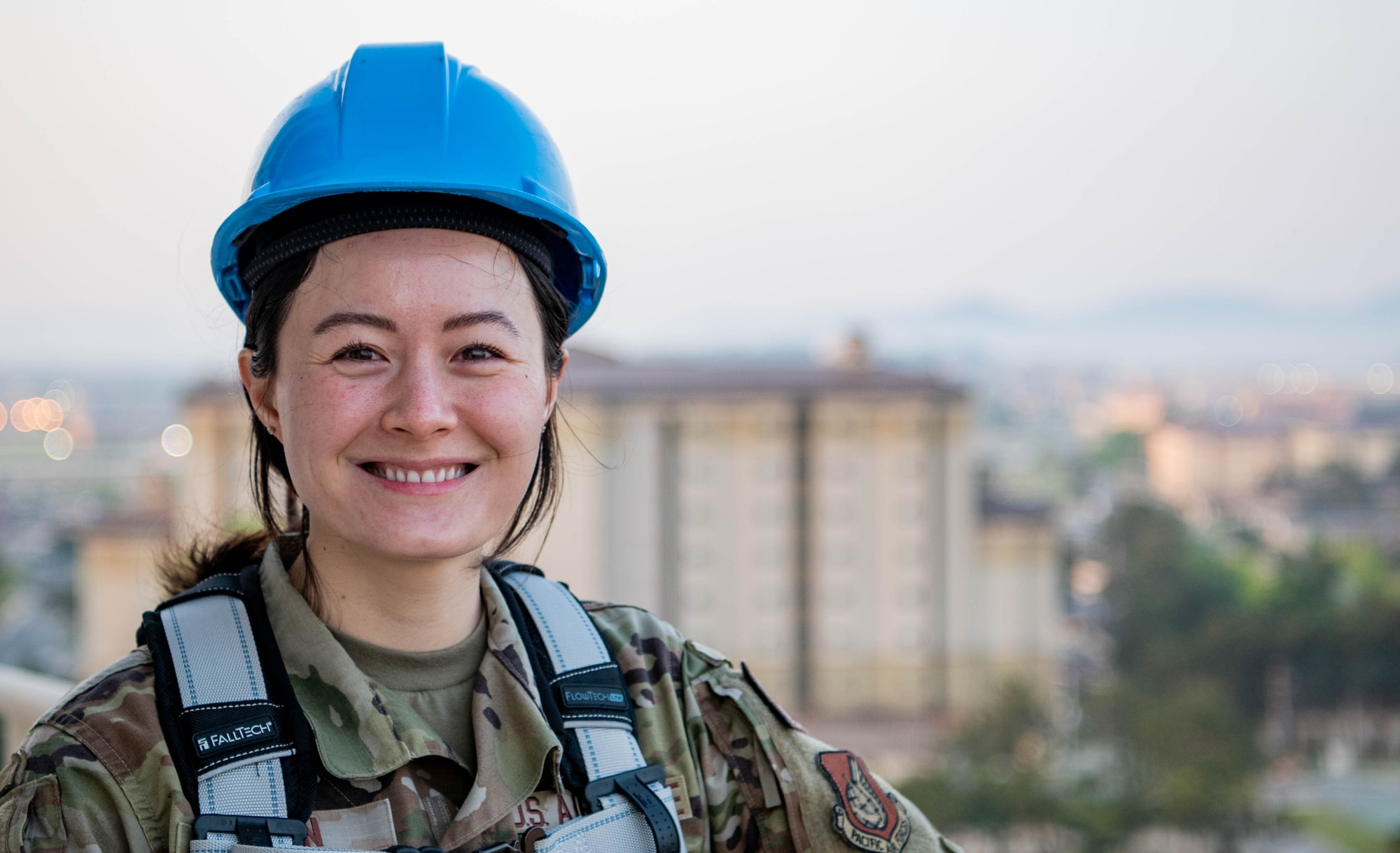 Abby Fenn stands with the view of Kunsan Air Base behind her.