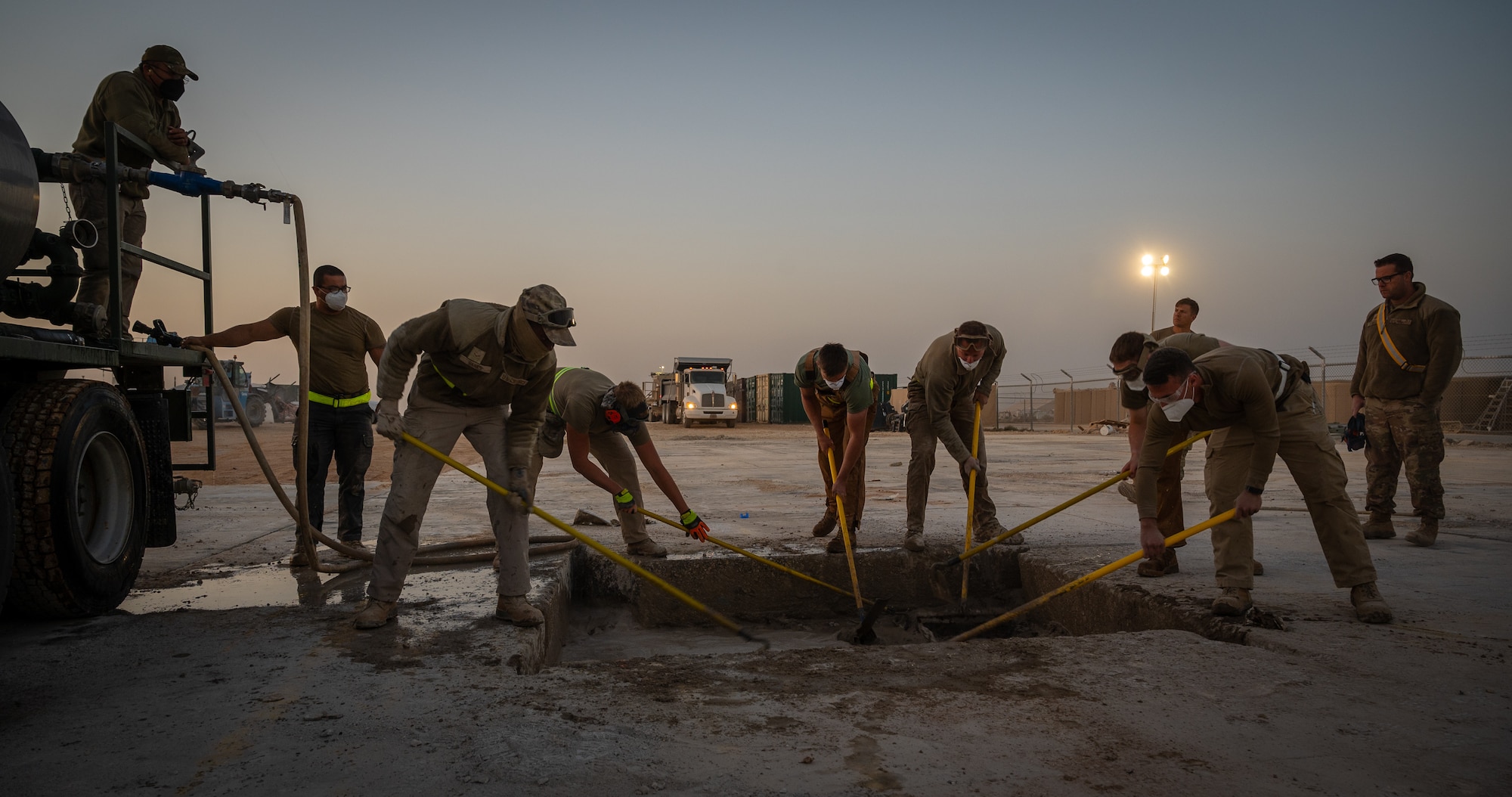 332d Expeditionary Civil Engineer Squadron Airmen mix water and a quick-dry filler to repair runway damage during a rapid airfield damage recovery exercise at an undisclosed location in Southwest Asia, May 12, 2022. RADR exercises test the ability of the 332d ECES to rapidly repair runways and runway support structures to recover and resume airfield operations after it has experienced significant damage. (U.S. Air Force photo by Master Sgt. Christopher Parr)