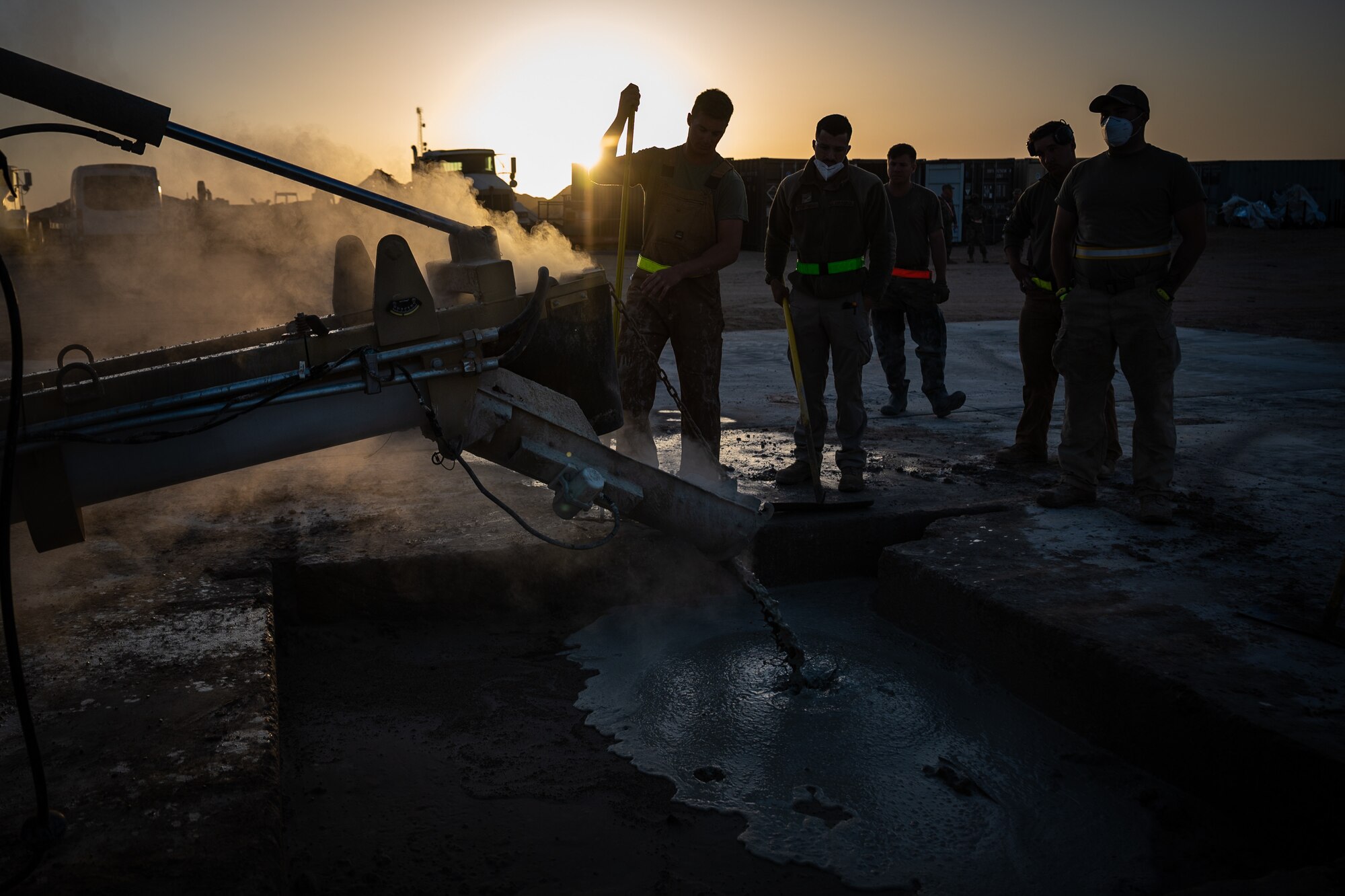 332d Expeditionary Civil Engineer Squadron Airmen pour water and quick-dry cement into a portion of damaged runway during a rapid airfield damage recovery exercise at an undisclosed location in Southwest Asia, May 12, 2022. RADR exercises test the ability of the 332d ECES to rapidly repair runways and runway support structures to recover and resume airfield operations after it has experienced significant damage. (U.S. Air Force photo by Master Sgt. Christopher Parr)