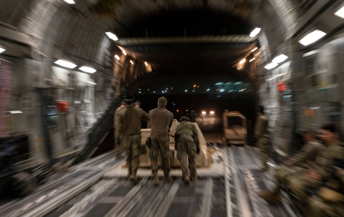 U.S. Airmen push cargo off a U.S. Air Force C-17 Globemaster III assigned to the 816th Expeditionary Airlift Squadron during a mission at an undisclosed location in Southwest Asia, March 5, 2022. The 816th EAS, deployed with Ninth Air Force (Air Forces Central), is responsible for delivering cargo and personnel to U.S. and partner nation forces’ bases, providing airpower to the U.S. Central Command area of responsibility. (U.S. Air Force photo by Tech. Sgt. Christopher Ruano)