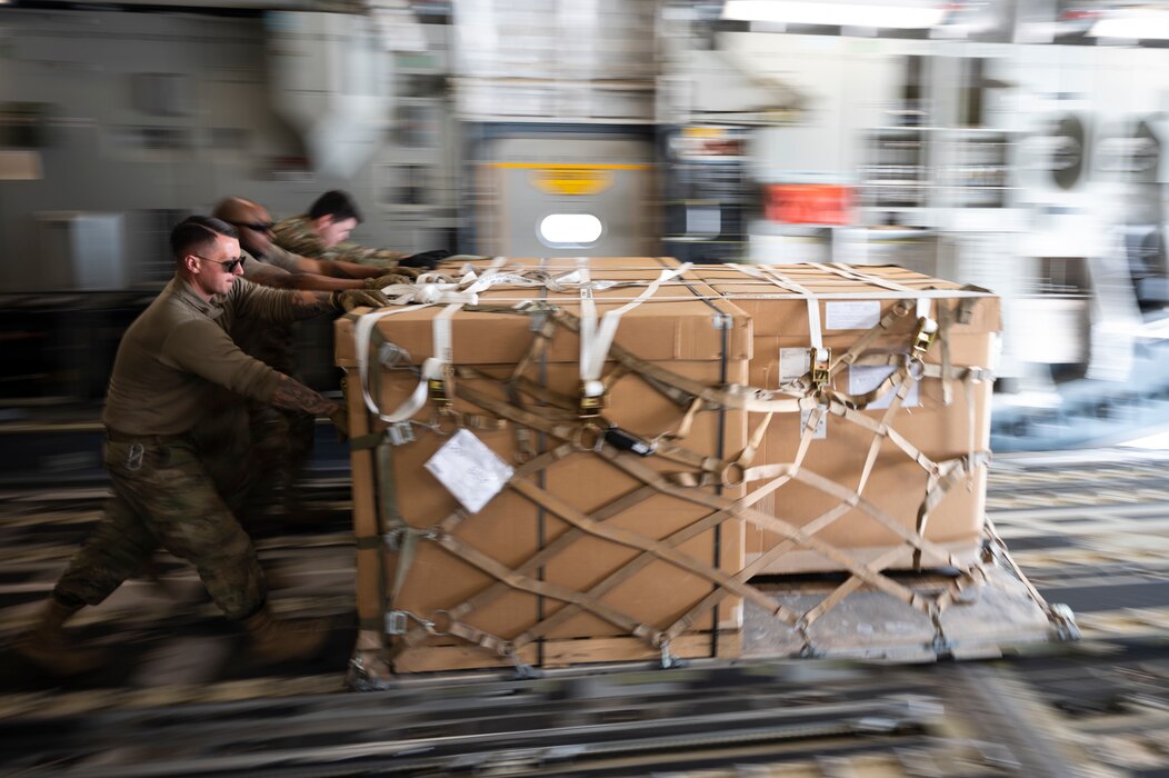 U.S. Airmen assigned to the 386th Expeditionary Logistics Readiness Squadron and 816th Expeditionary Airlift Squadron offload cargo from a U.S. Air Force C-17 Globemaster III at Ali Al Salem Air Base, Kuwait, March 2, 2022. The C-17 Globemaster III is capable of rapid strategic delivery of troops and cargo directly to main or forward operating bases in the U.S. Central Command area of responsibility. (U.S. Air Force photo by Staff Sgt. Joseph Pick)