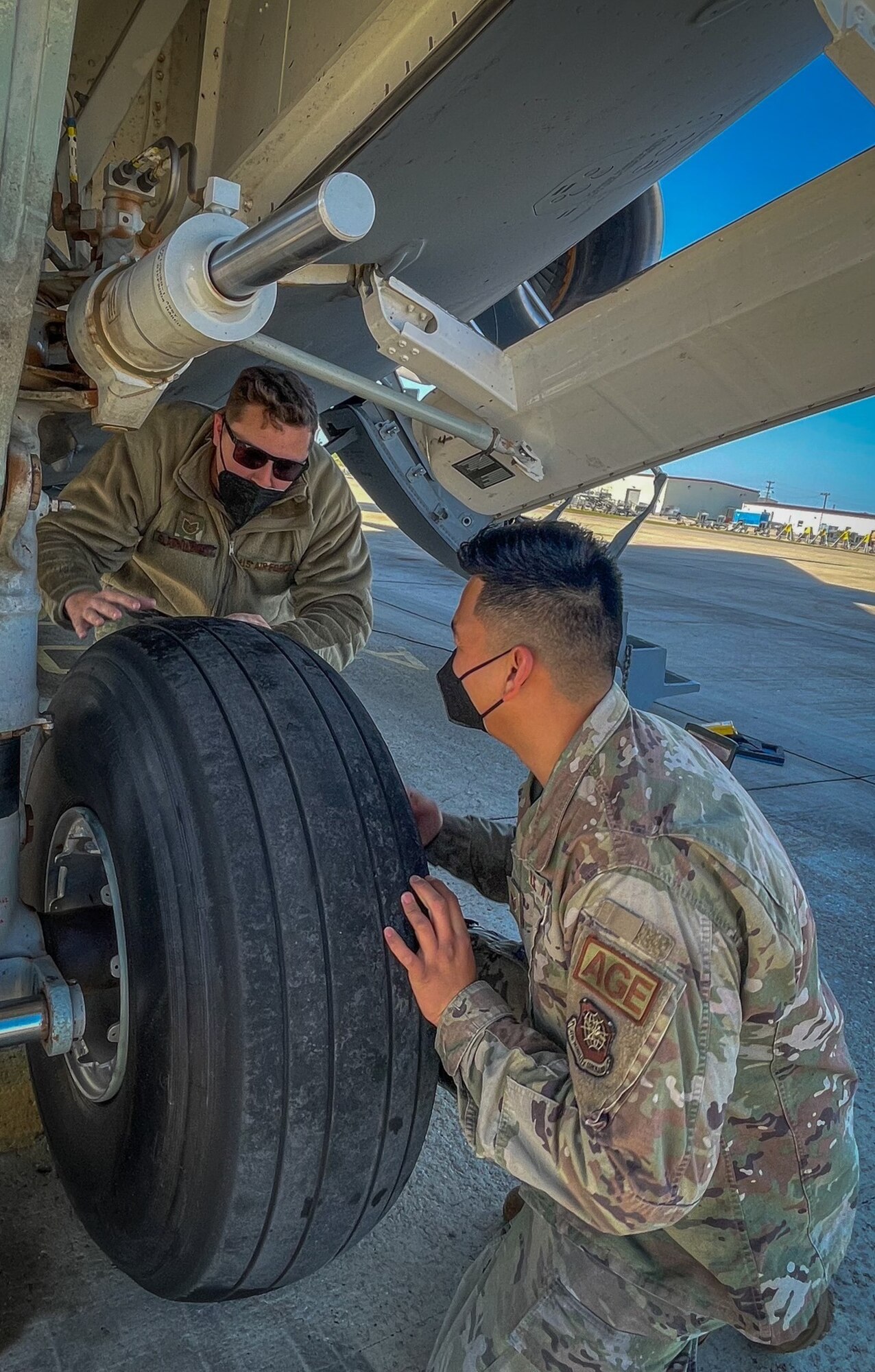 Tech. Sgt. Ozzie Slawnikowski, left, 725th Air Mobility Squadron (AMS) crew chief non-commissioned officer in charge teaches Staff Sgt. Reynaldo Guevarra, right, 725th AMS aerospace ground equipment craftsman, about tire changes on a C-17 Globemaster III during a multi-capable airman (MCA) exercise at Naval Station Rota, Spain, Feb. 11, 2022. During the weeklong MCA exercise, 725th AMS participated in a familiarization of new tasks using real equipment as well as virtual reality training tools. An MCA is critical to enabling agile combat employment, which is a proactive and reactive operational scheme of maneuver designed to address the challenges of projecting combat power across the globe with a significantly reduced global footprint, increased risk from adversarial technological advances, and fiscal and political constraints. (Courtesy photo)