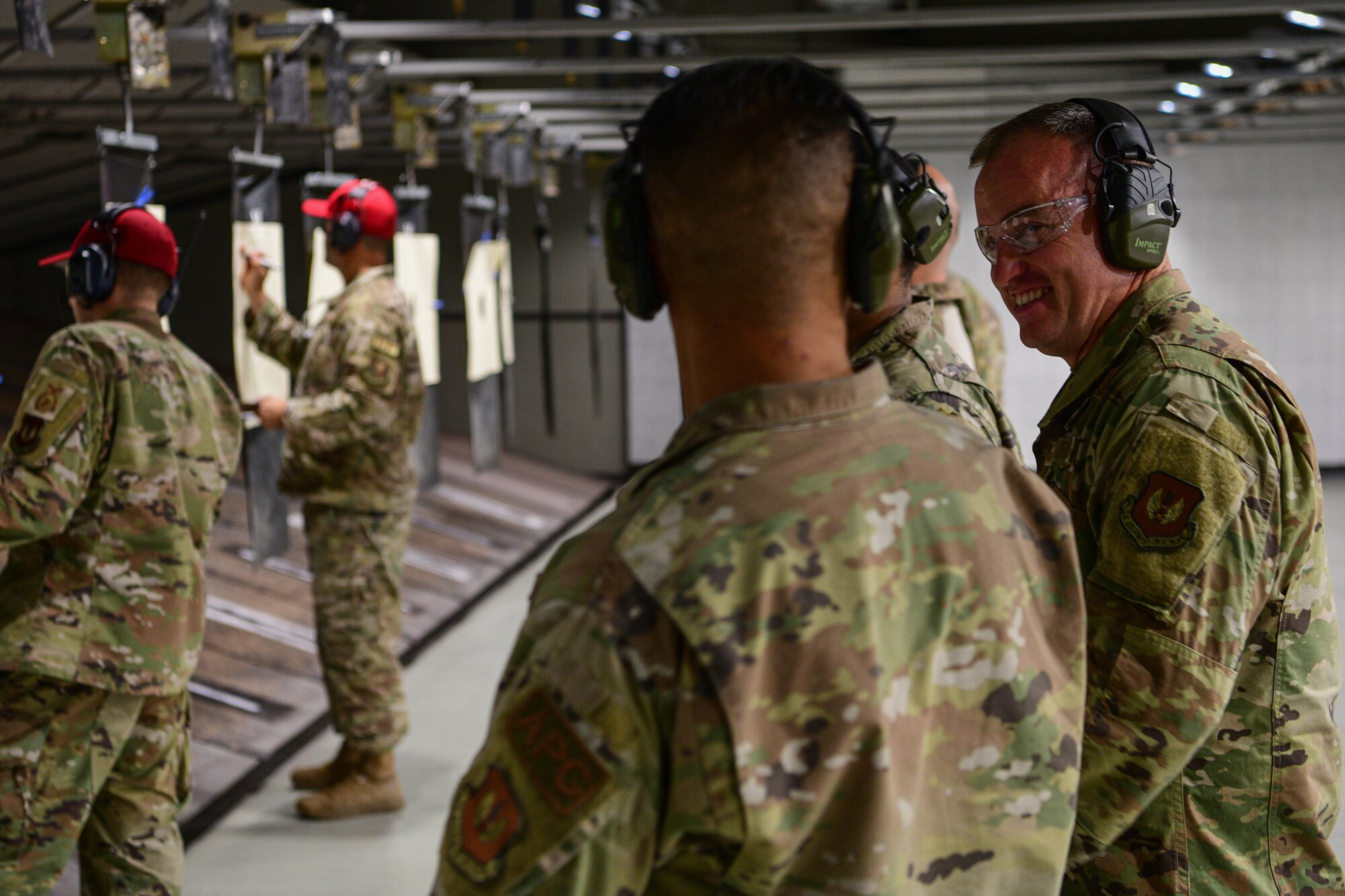 U.S. Air Force Chief Master Sgt. Jeremy Unterseher, 31st Fighter Wing command chief, right, watches Combat Arms instructors score targets during the 2022 Excellence in Competition Pistol match at Aviano Air Base, Italy, May 17, 2022. During this event Wyverns competed in marksmanship challenges against their fellow wingmen. Police Week has been held annually since 1962, after President Kennedy designated the week of May 15 in remembrance of officers who have died in the line of duty. (U.S. Air Force photo by Airman 1st Class Calopedis)