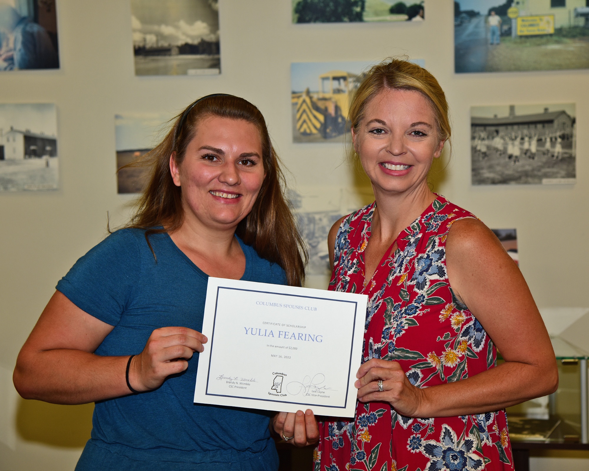 Yulia Fearing, 37th Flying Training Squadron spouse is presented a $2,000 scholarship by Brandy Womble, Columbus Spouses Club president, for leadership qualities and community involvement. The CSC raised over $11,500, which was donated directly back to the community.  (U.S. Air Force photo by Melissa Duncan-Doublin)