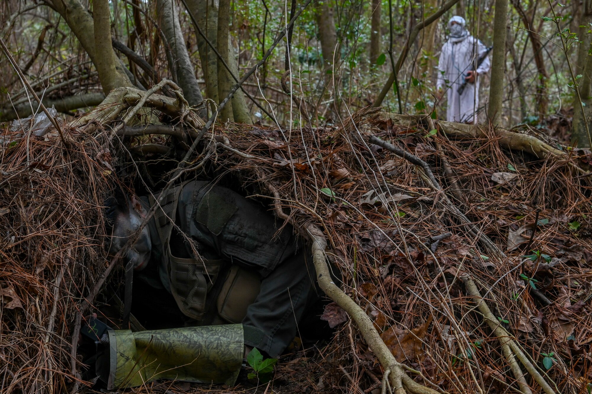Mier demonstrated how to create an evasion shelter and effectively utilize equipment while evading opposing forces. (U.S. Air Force photo by Senior Airman Kylie Barrow)