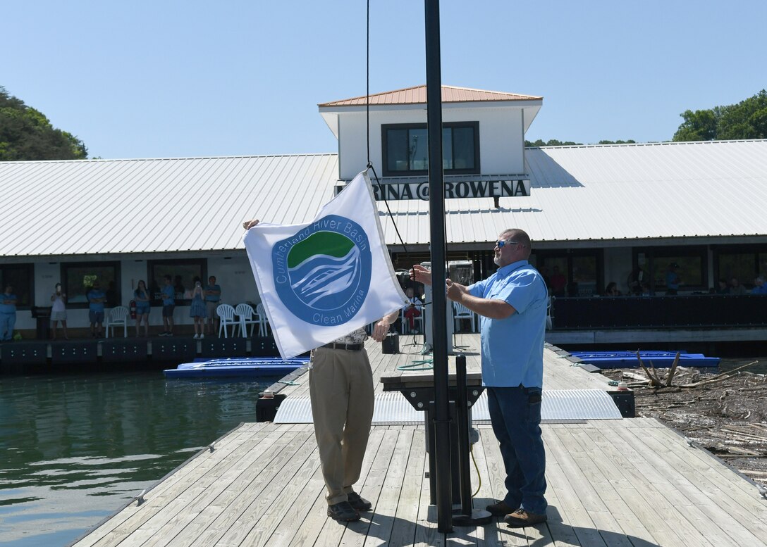Marina@Rowena General Manager David Dyson and Nashville District Eastern Kentucky Operations Manager Michael Lapina raise the Clean Marina flag at the award ceremony held at the Marina@Rowena in Albany, KY on May 17, 2022.