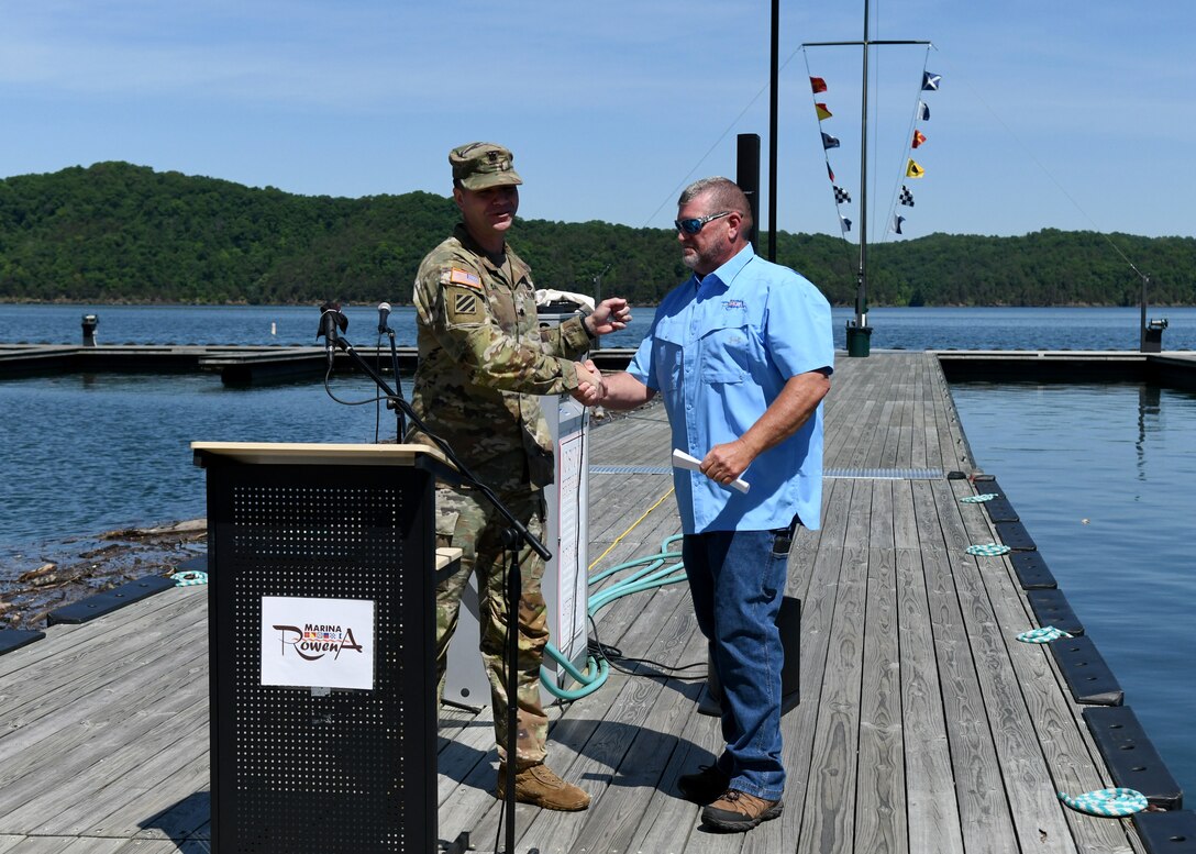 Nashville District Commander Lt. Col. Joseph Sahl congratulates Marina@Rowena General Manager David Dyson with a handshake and commander’s challenge coin for his hard work and diligence during the Cumberland River Basin Clean Marina Program certification, earning the 2022 Clean Marina Award in Albany, Ky on May 17, 2022.