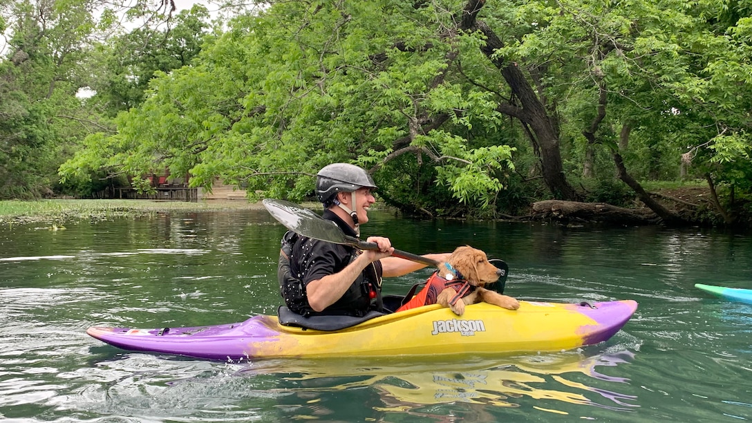 Coach and his dog kayak down the river.