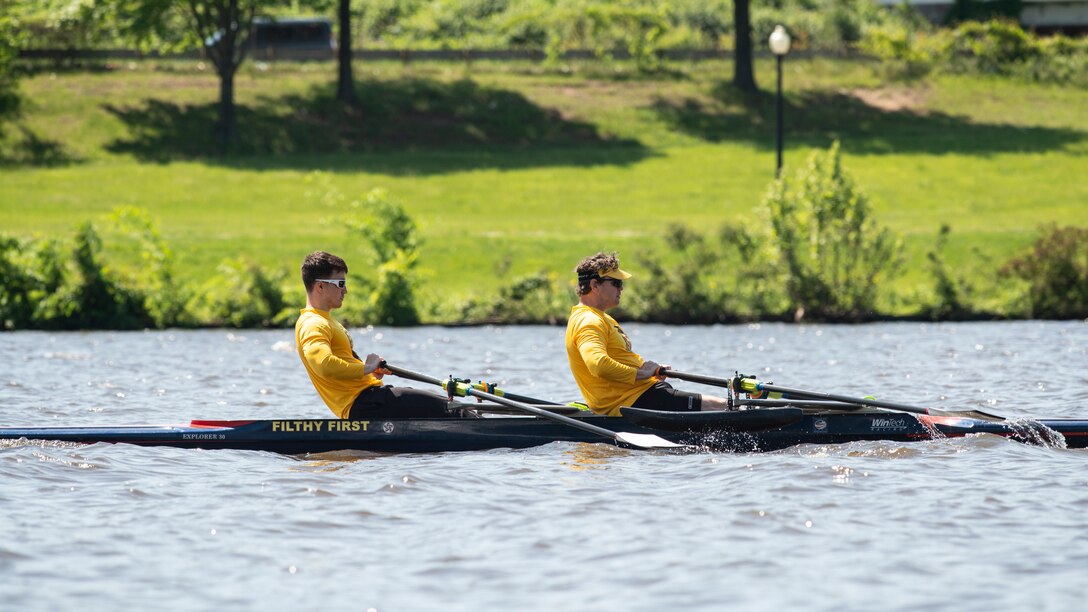 Veteran service member and coach practice rowing.