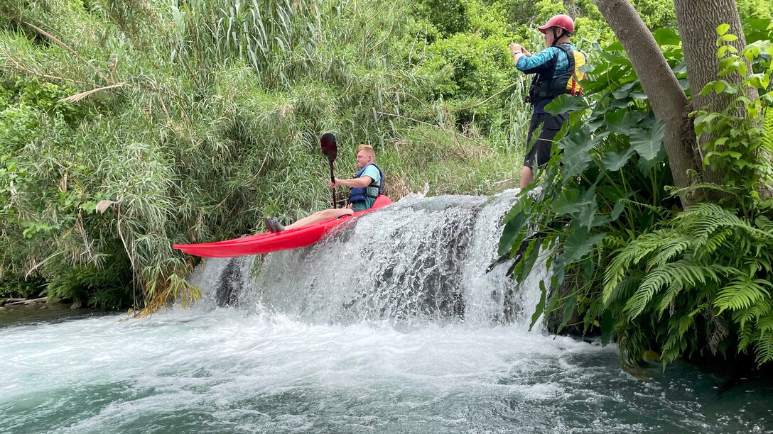 RSM kayaks over small waterfall.